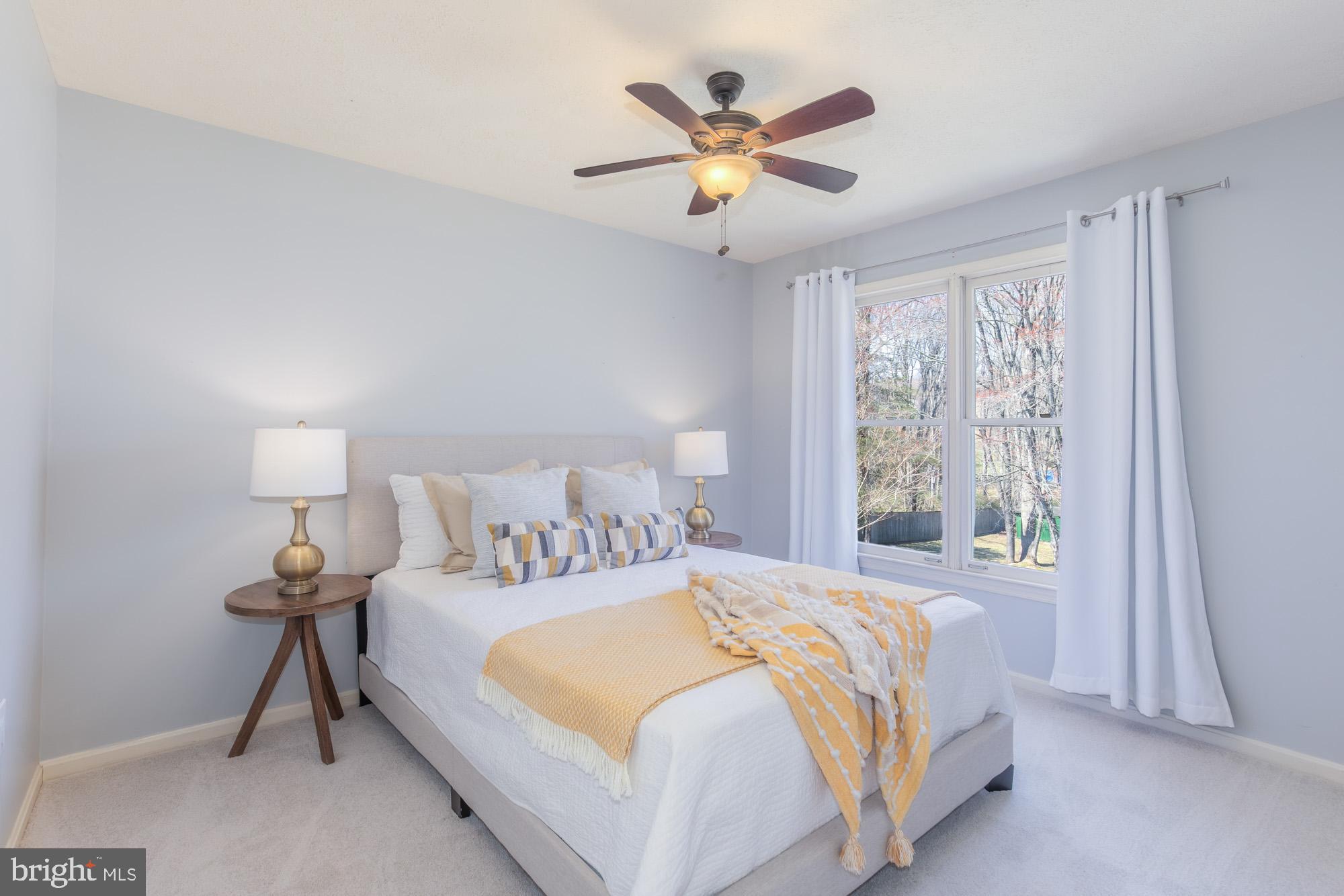 16217 Whitehaven Road Silver Spring, MD 20906 - Photo 40 of 50 a bedroom with a large bed and a chandelier