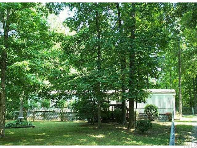 136 Mountain Brook Road Rougemont, NC 27572 - Photo 1 of 1 a view of a house with a tree in a yard