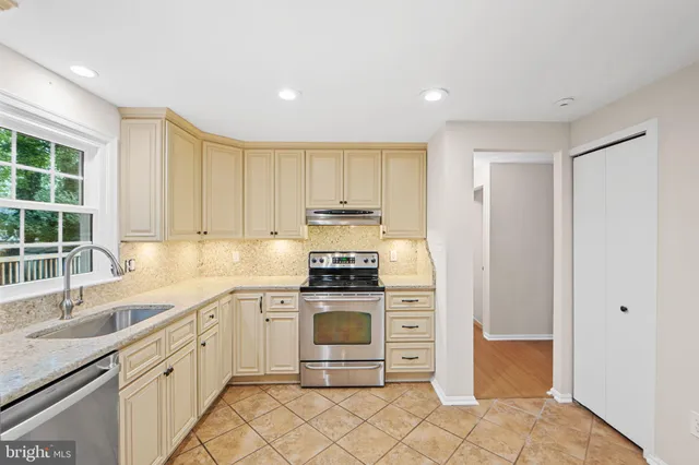 a kitchen with stainless steel appliances granite countertop a stove and a refrigerator