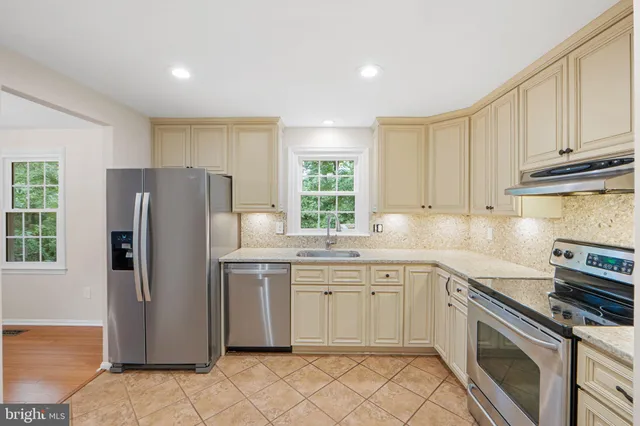 a kitchen with a sink stove and refrigerator