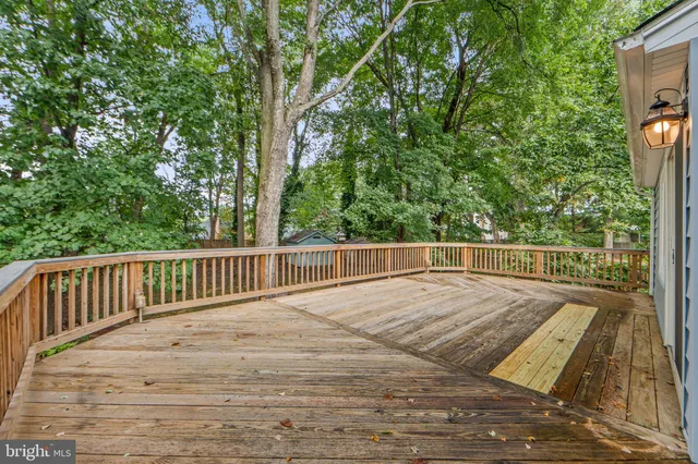 a view of balcony with wooden floor and fence