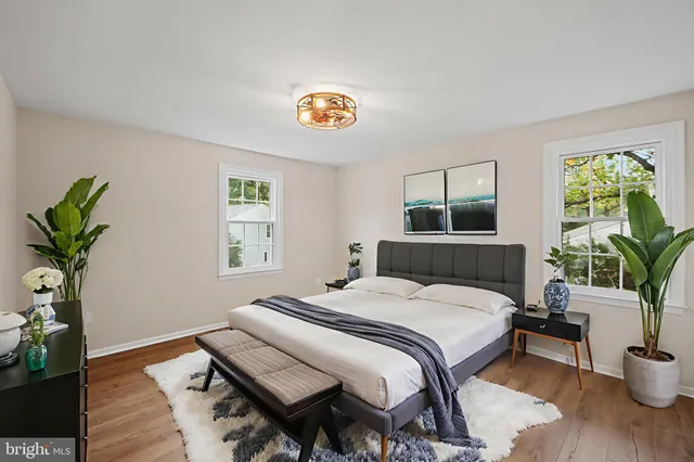 a bedroom with a bed and a potted plant