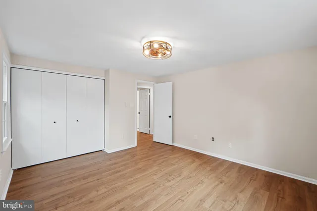 a view of a room with wooden floor and a window