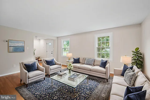 a living room with furniture a rug and a window