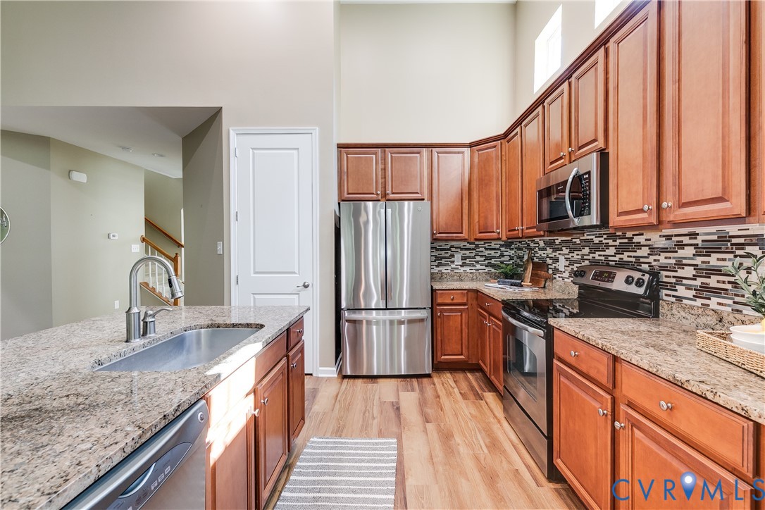 7538 South Franklins Way Quinton, VA 23141 - Photo 20 of 48 a kitchen with stainless steel appliances granite countertop a sink stove and refrigerator