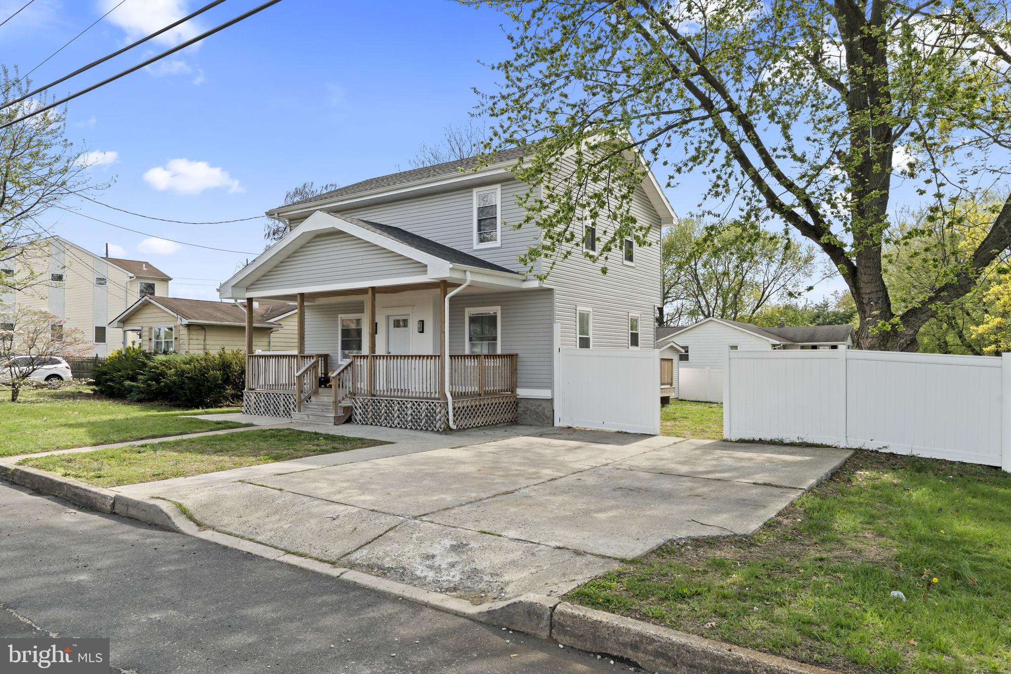 1901 Jackson Street Cinnaminson, NJ 08077 - Photo 1 of 40 a front view of a house with a yard and garage