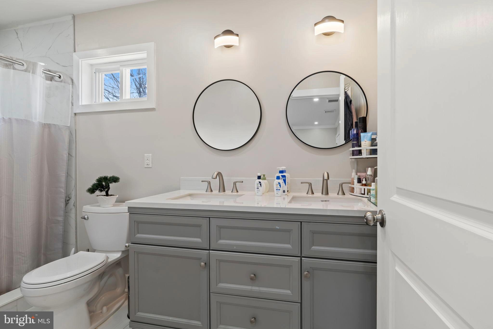 1901 Jackson Street Cinnaminson, NJ 08077 - Photo 16 of 40 a bathroom with a toilet a sink and a mirror