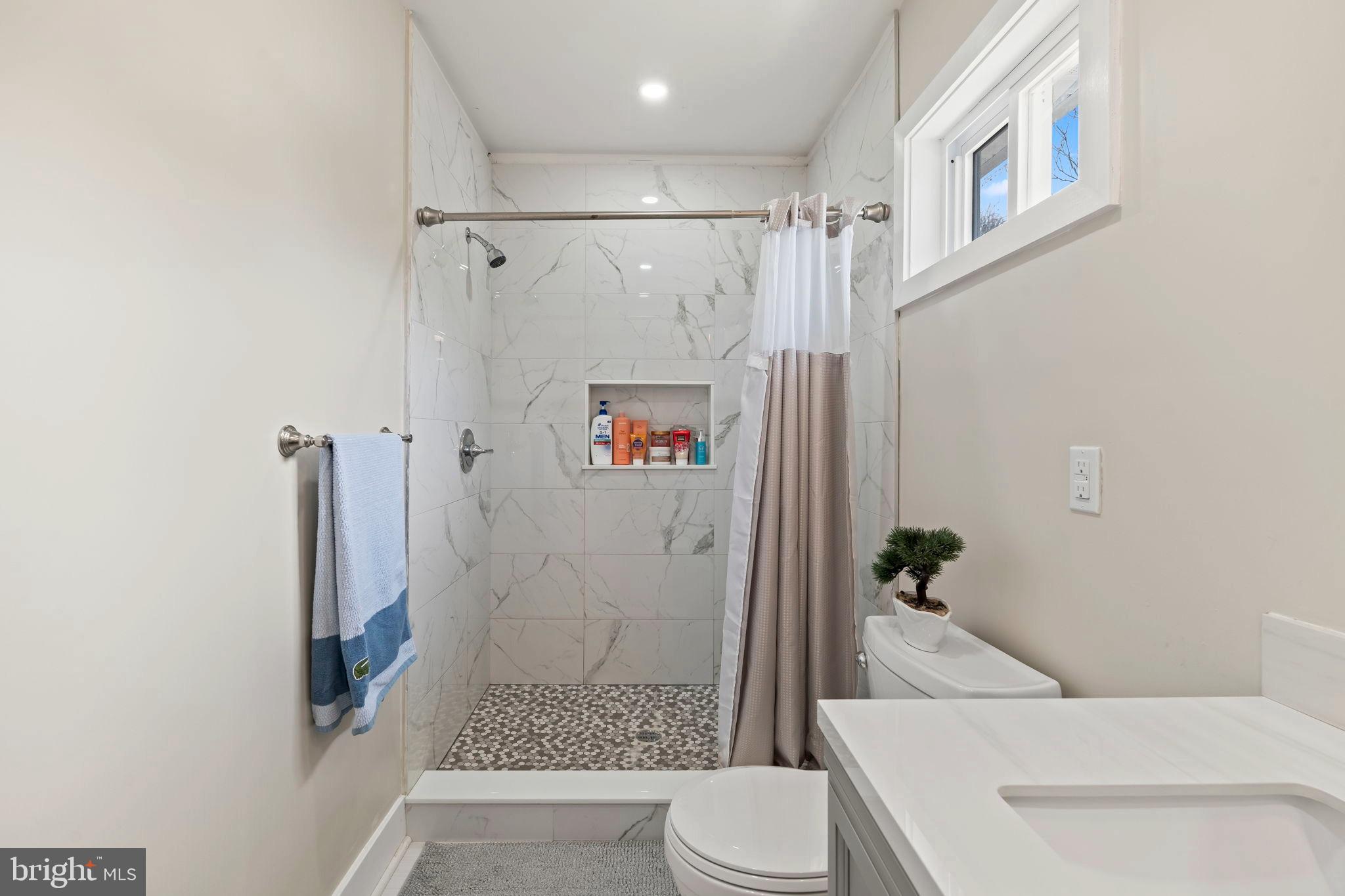 1901 Jackson Street Cinnaminson, NJ 08077 - Photo 17 of 40 a bathroom with a shower toilet and sink