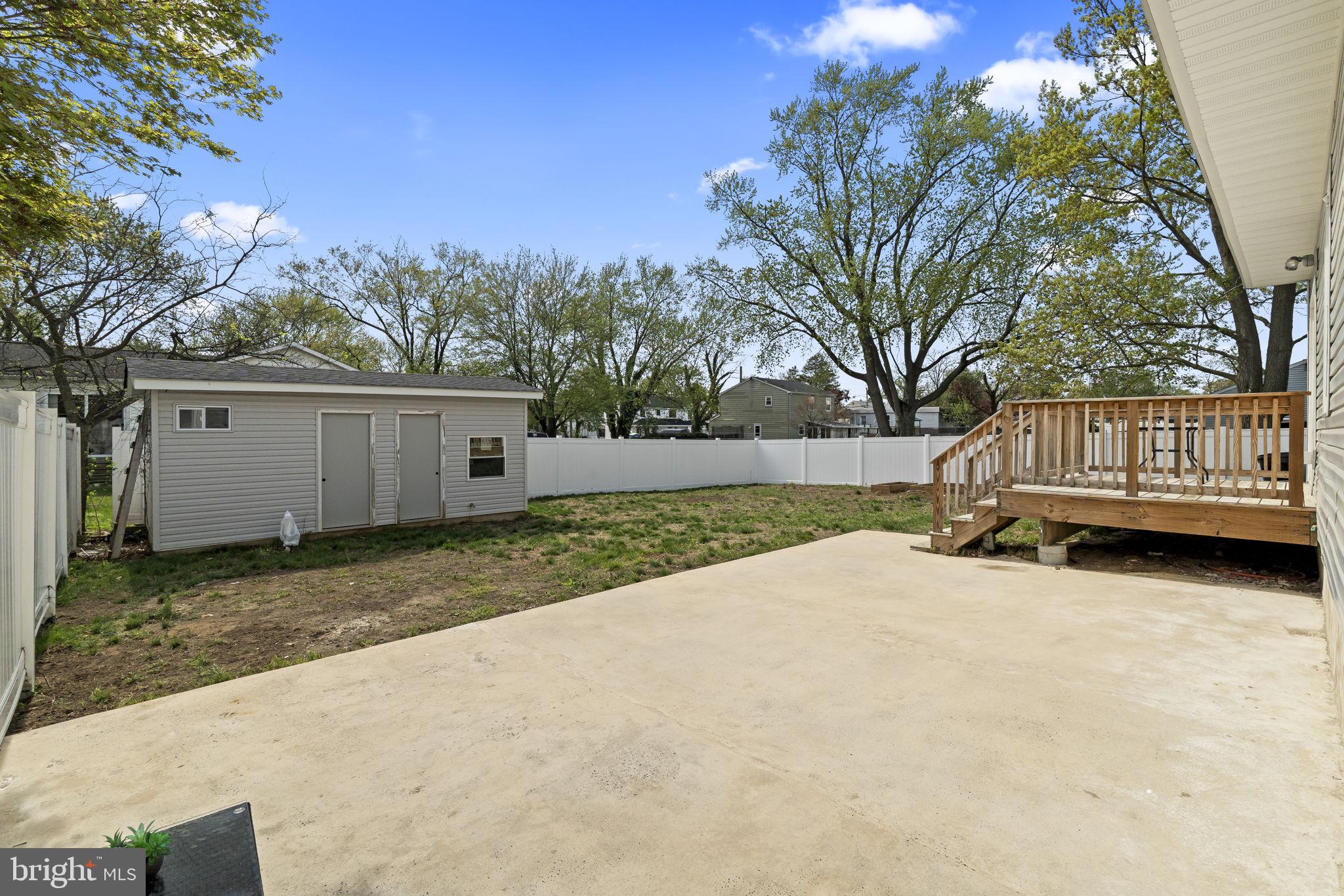 1901 Jackson Street Cinnaminson, NJ 08077 - Photo 34 of 40 a view of backyard with wooden fence and large trees