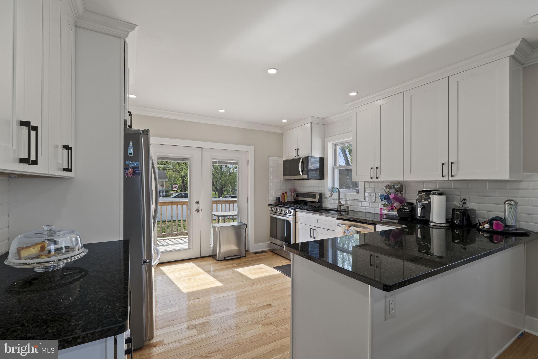 1901 Jackson Street Cinnaminson, NJ 08077 - Photo 5 of 40 a kitchen with granite countertop white cabinets and stainless steel appliances