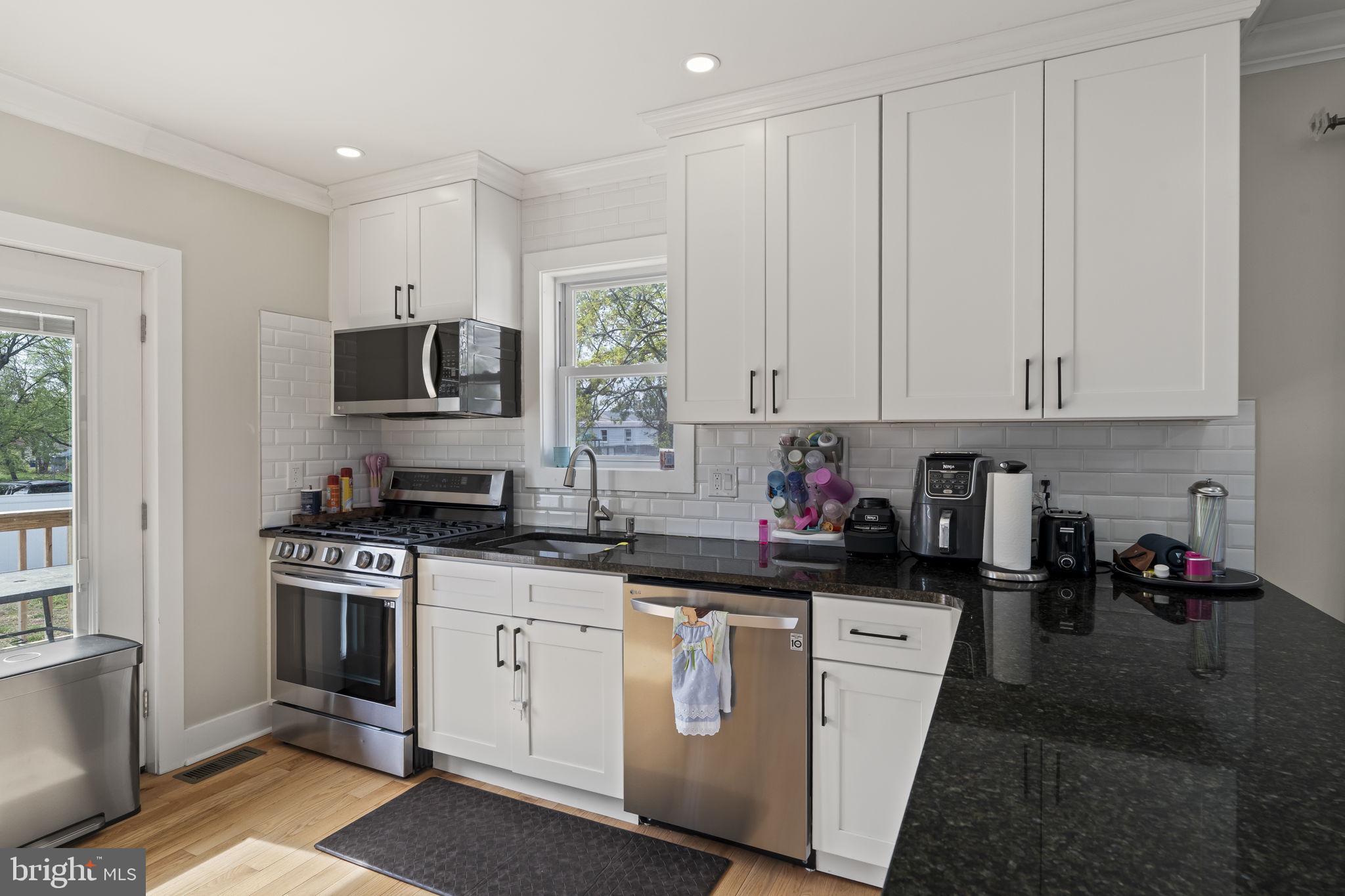 1901 Jackson Street Cinnaminson, NJ 08077 - Photo 6 of 40 a kitchen with white cabinets and appliances