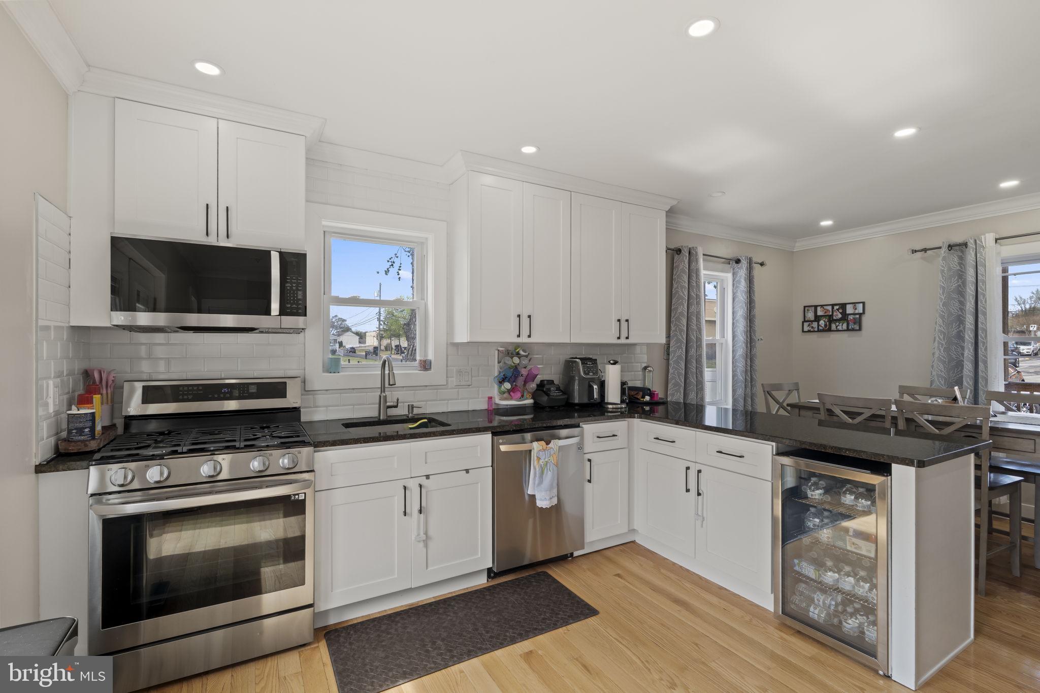 1901 Jackson Street Cinnaminson, NJ 08077 - Photo 7 of 40 a kitchen with a sink stove and microwave