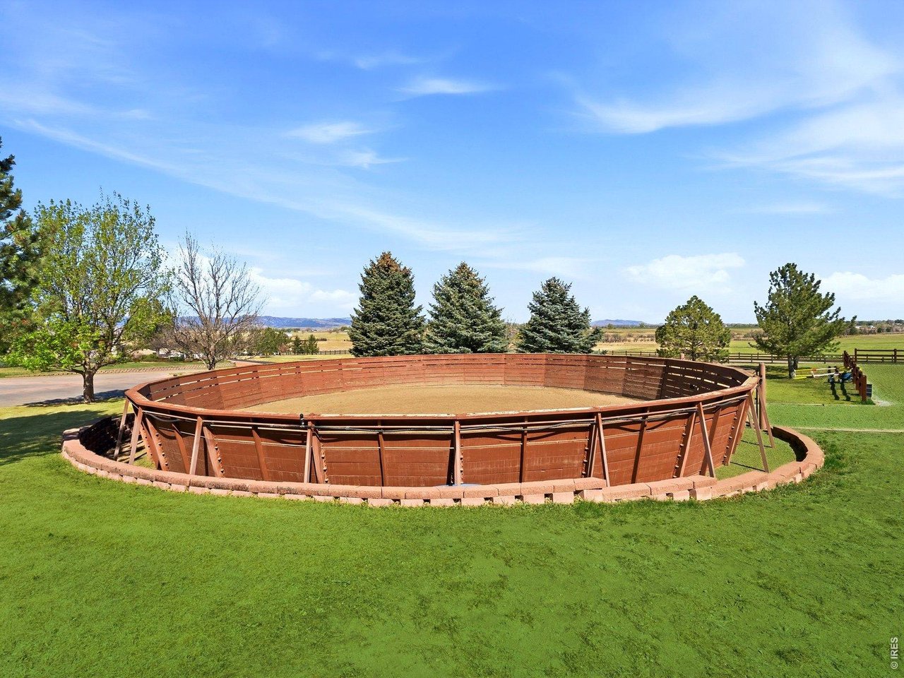 15383 East County Line Road Berthoud, CO 80513 - Photo 6 of 47 a view of a big yard with swimming pool and wooden fence