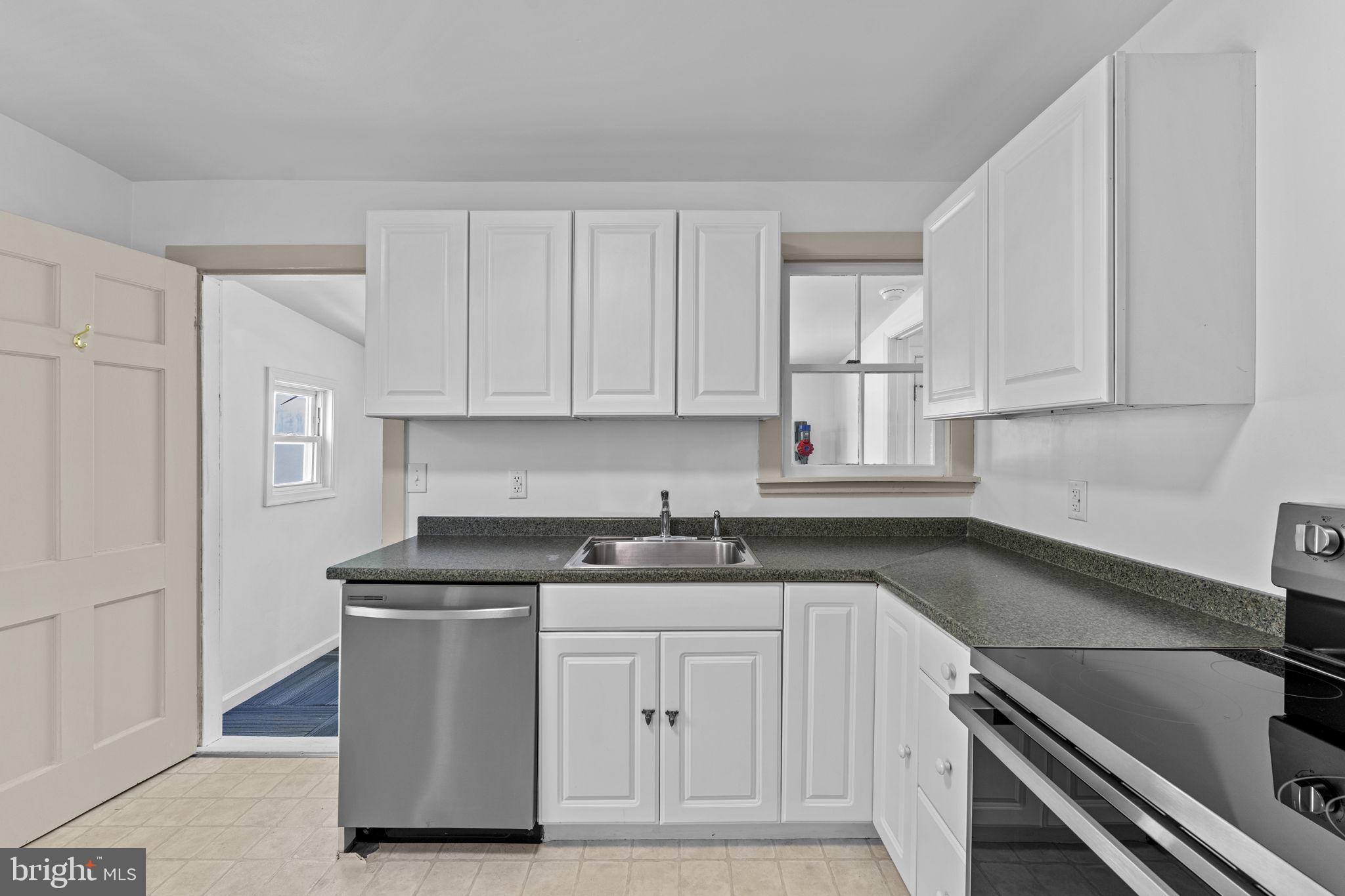 216 Walnut Street Berryville, VA 22611 - Photo 26 of 36 a kitchen with stainless steel appliances granite countertop a sink stove and cabinets