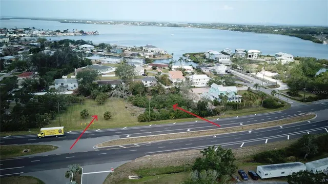 an aerial view of a residential houses with city view