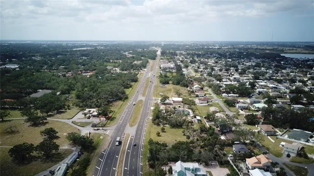an aerial view of a residential houses with city view