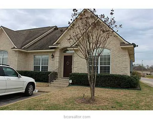 a view of a car park front of a house