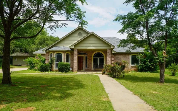 a front view of house with yard and green space