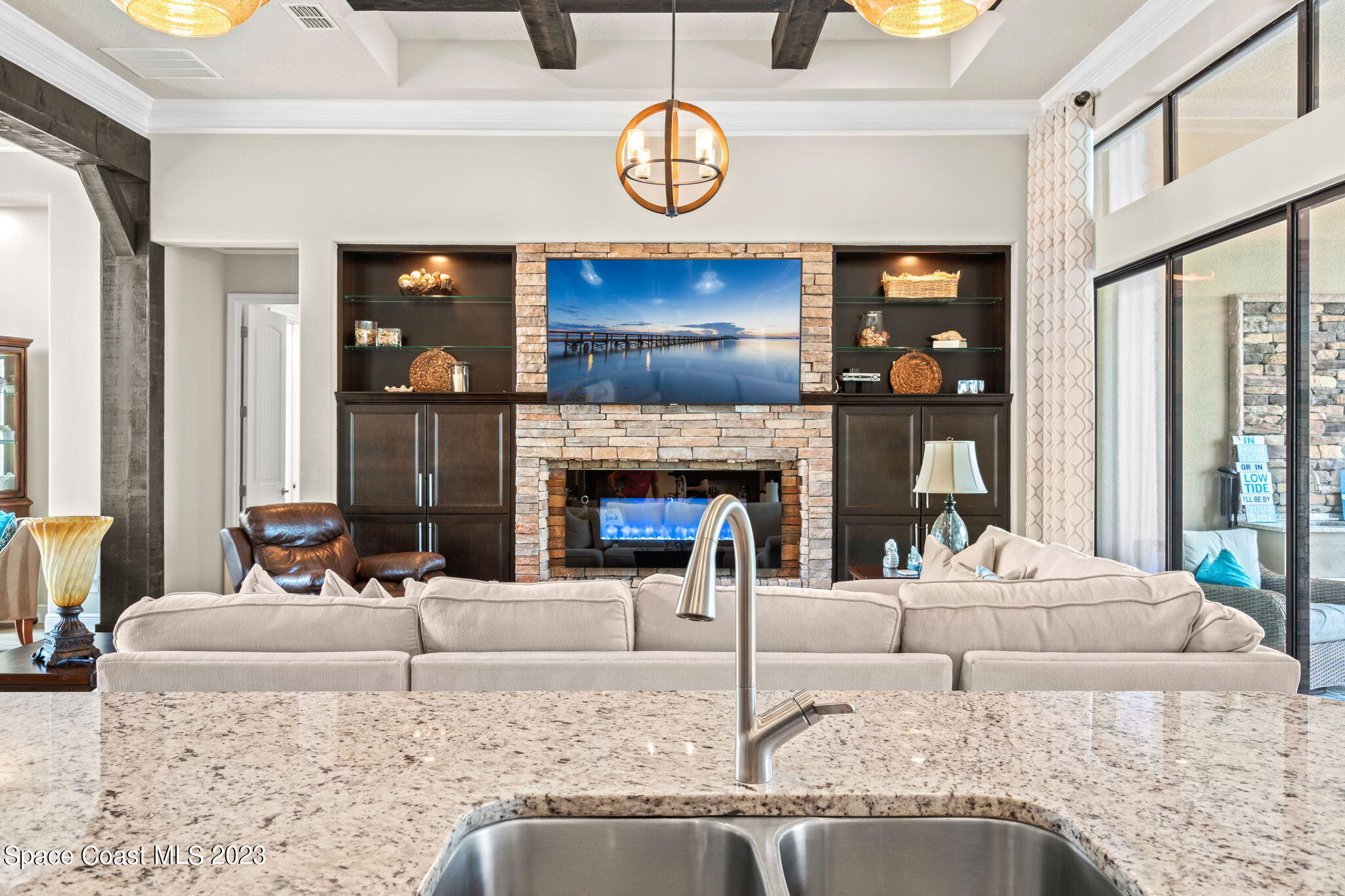 5530 Calder Drive Melbourne, FL 32940 - Photo 16 of 63 a living room with fireplace furniture and a large window