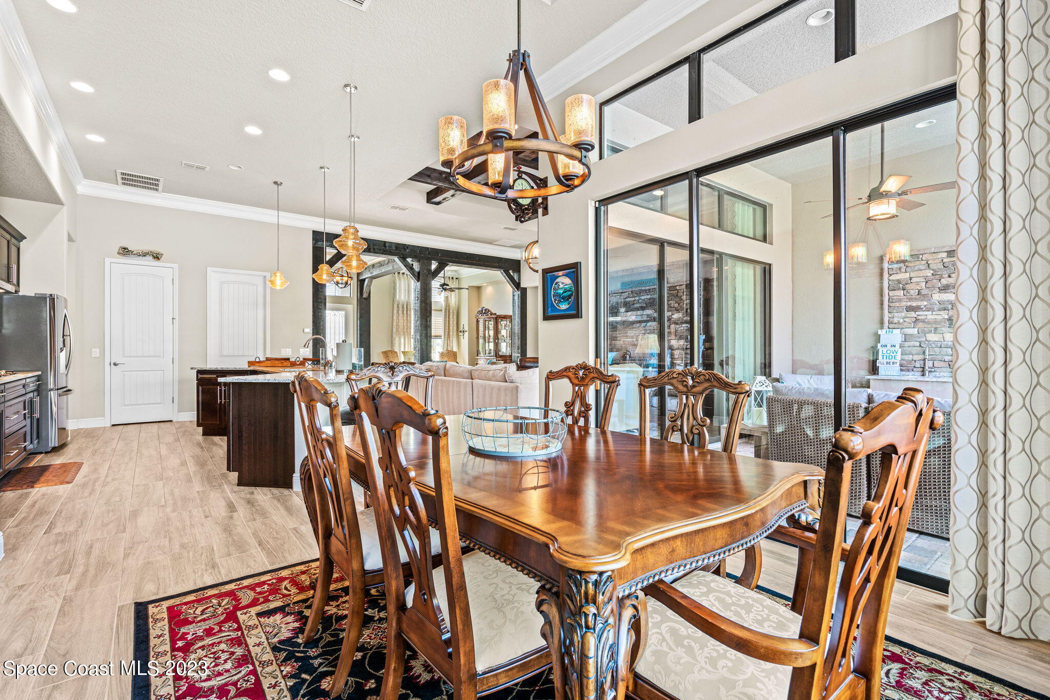5530 Calder Drive Melbourne, FL 32940 - Photo 20 of 63 a dining room with furniture a chandelier and wooden floor
