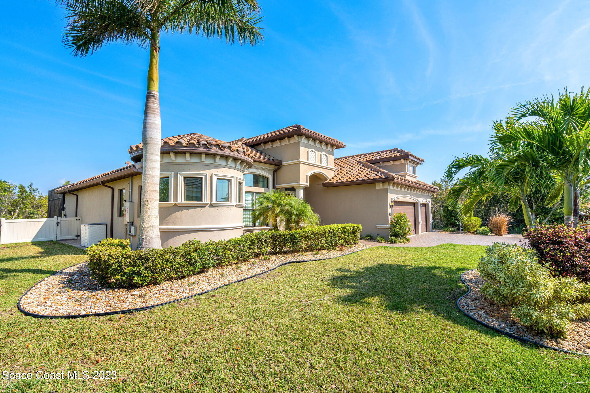 5530 Calder Drive Melbourne, FL 32940 - Photo 2 of 63 a front view of a house with a yard and garage