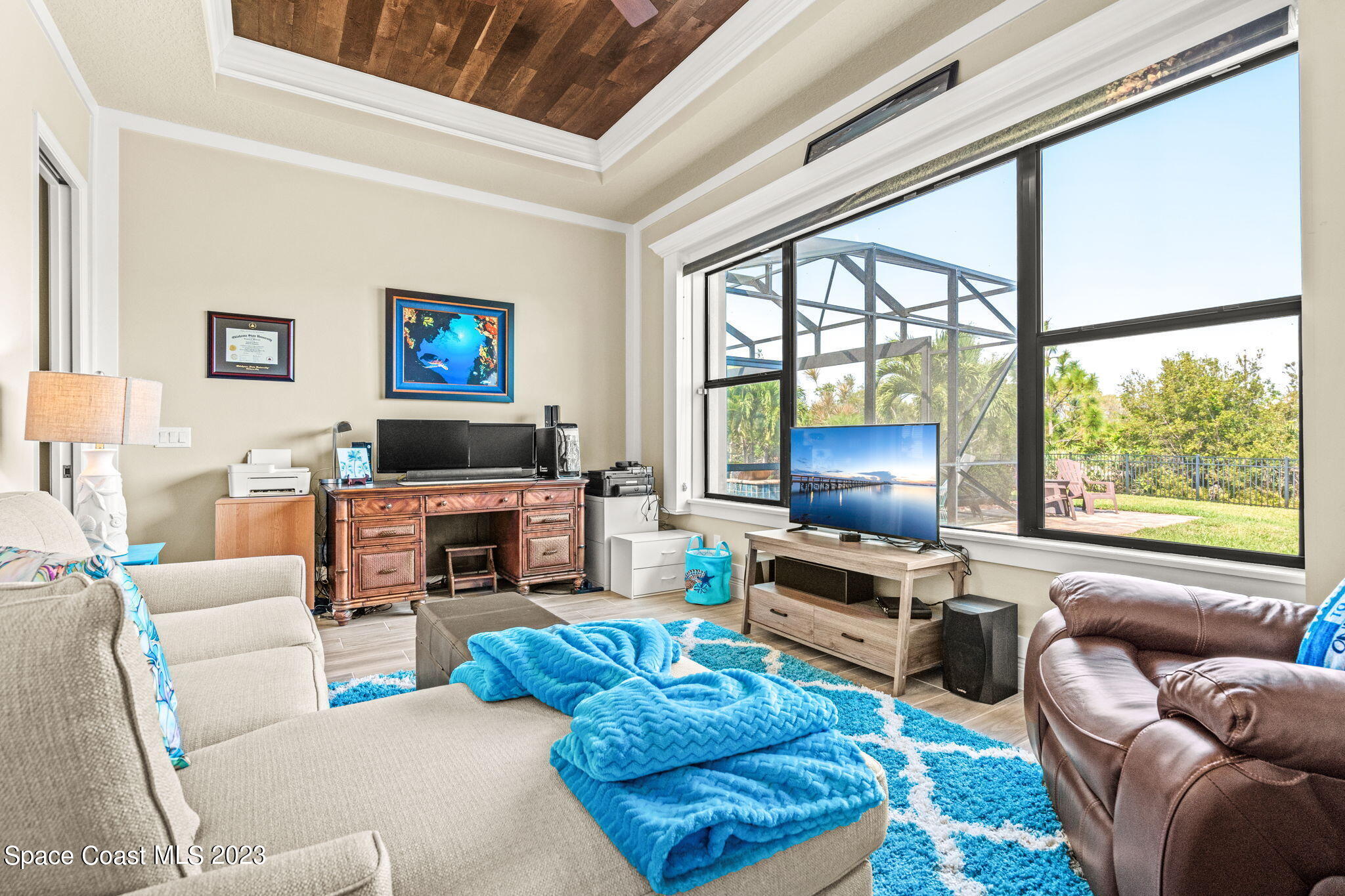 5530 Calder Drive Melbourne, FL 32940 - Photo 24 of 63 a living room with furniture a fireplace and a large window
