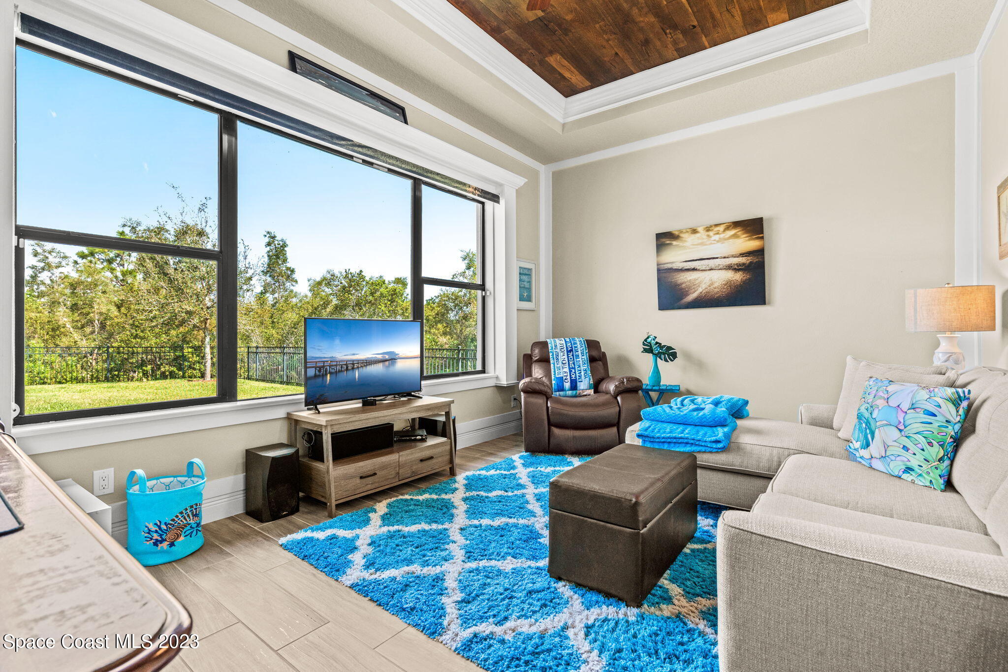 5530 Calder Drive Melbourne, FL 32940 - Photo 25 of 63 a living room with furniture and a flat screen tv