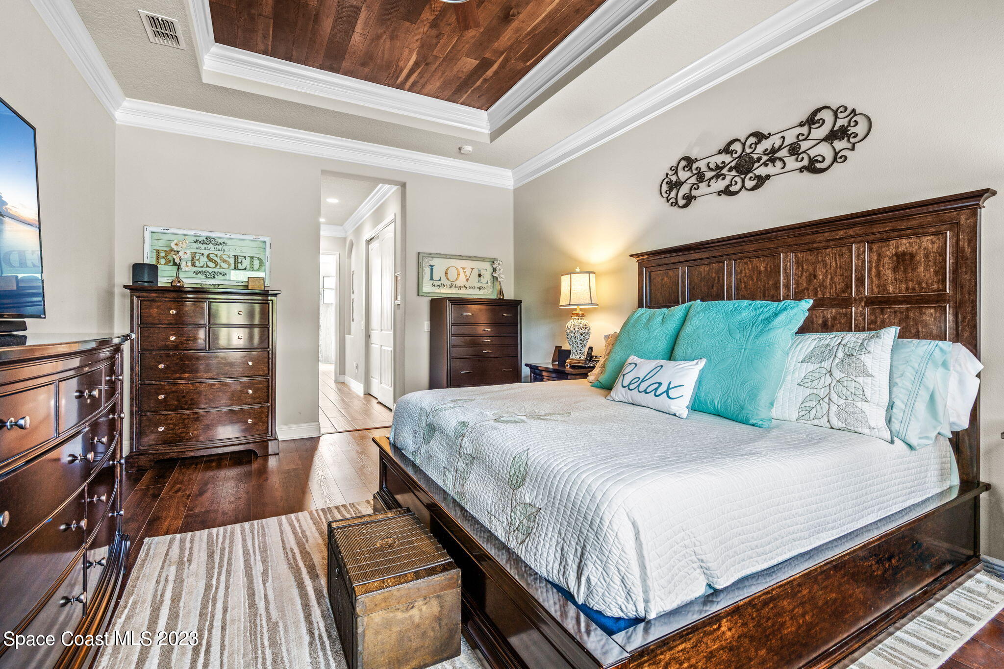 5530 Calder Drive Melbourne, FL 32940 - Photo 27 of 63 a bedroom with a bed and wooden floor