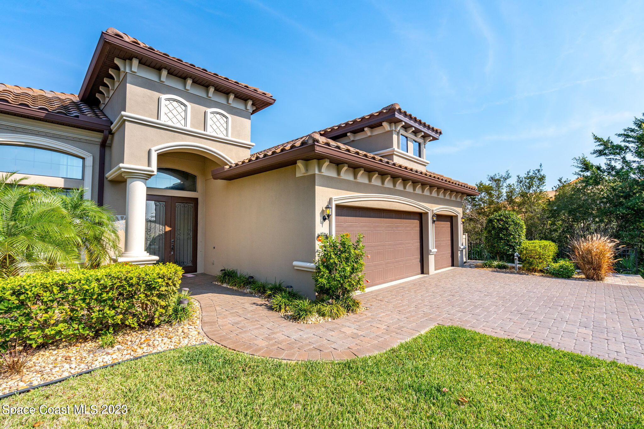 5530 Calder Drive Melbourne, FL 32940 - Photo 3 of 63 a front view of a house with garden
