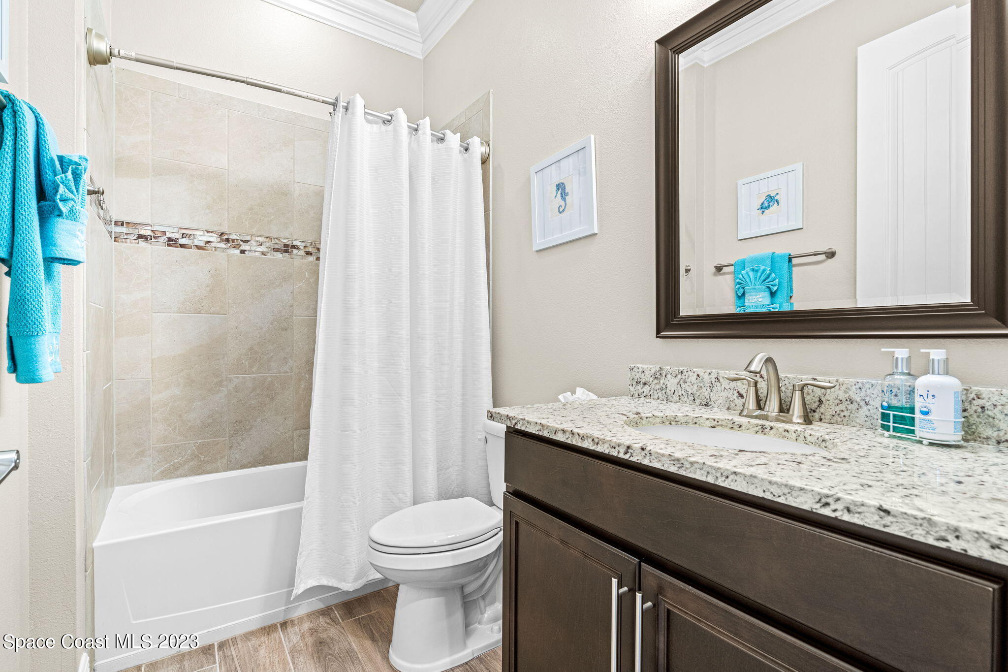 5530 Calder Drive Melbourne, FL 32940 - Photo 33 of 63 a bathroom with a granite countertop sink toilet and shower