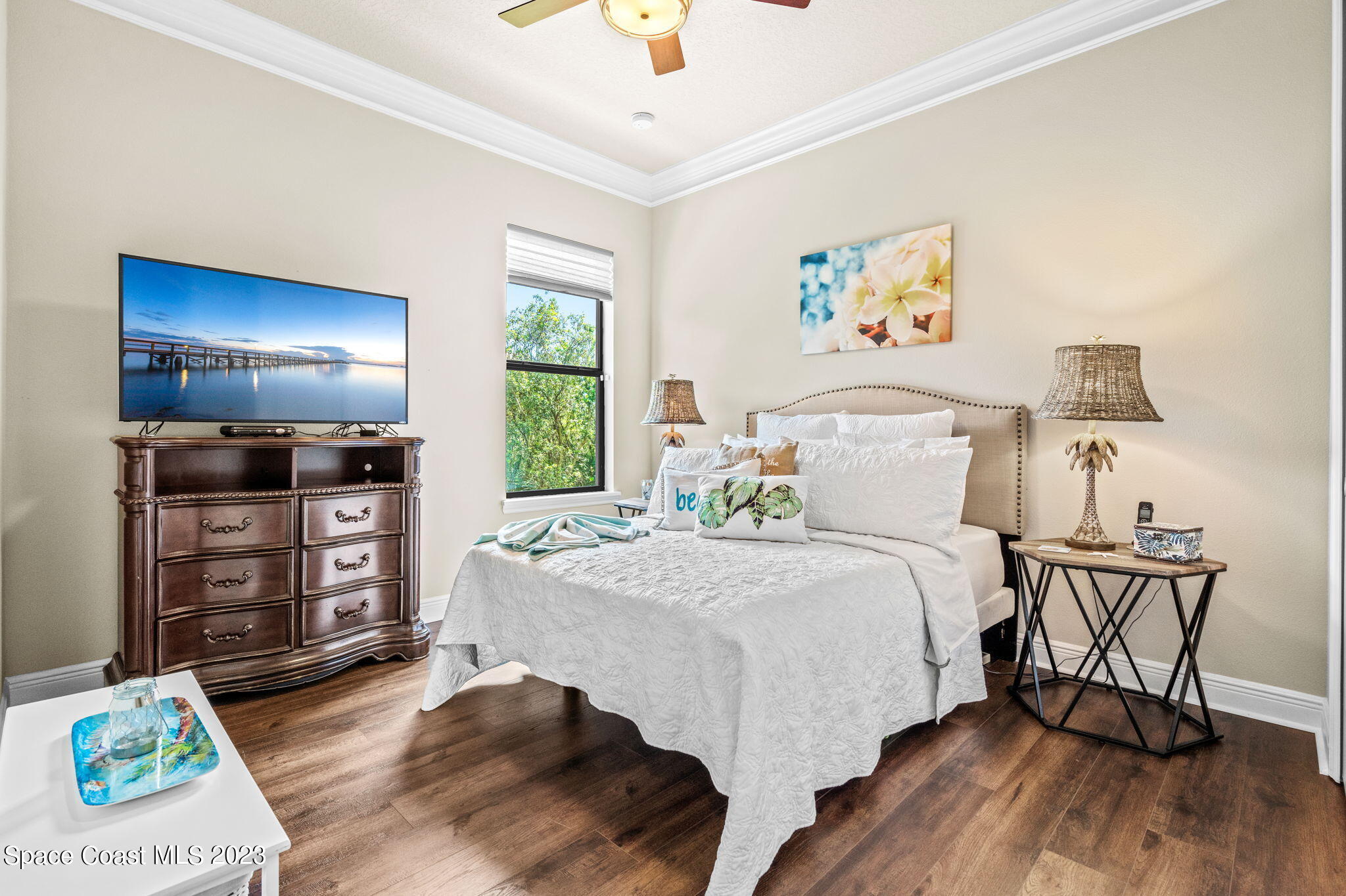 5530 Calder Drive Melbourne, FL 32940 - Photo 34 of 63 a bedroom with a bed and a chandelier