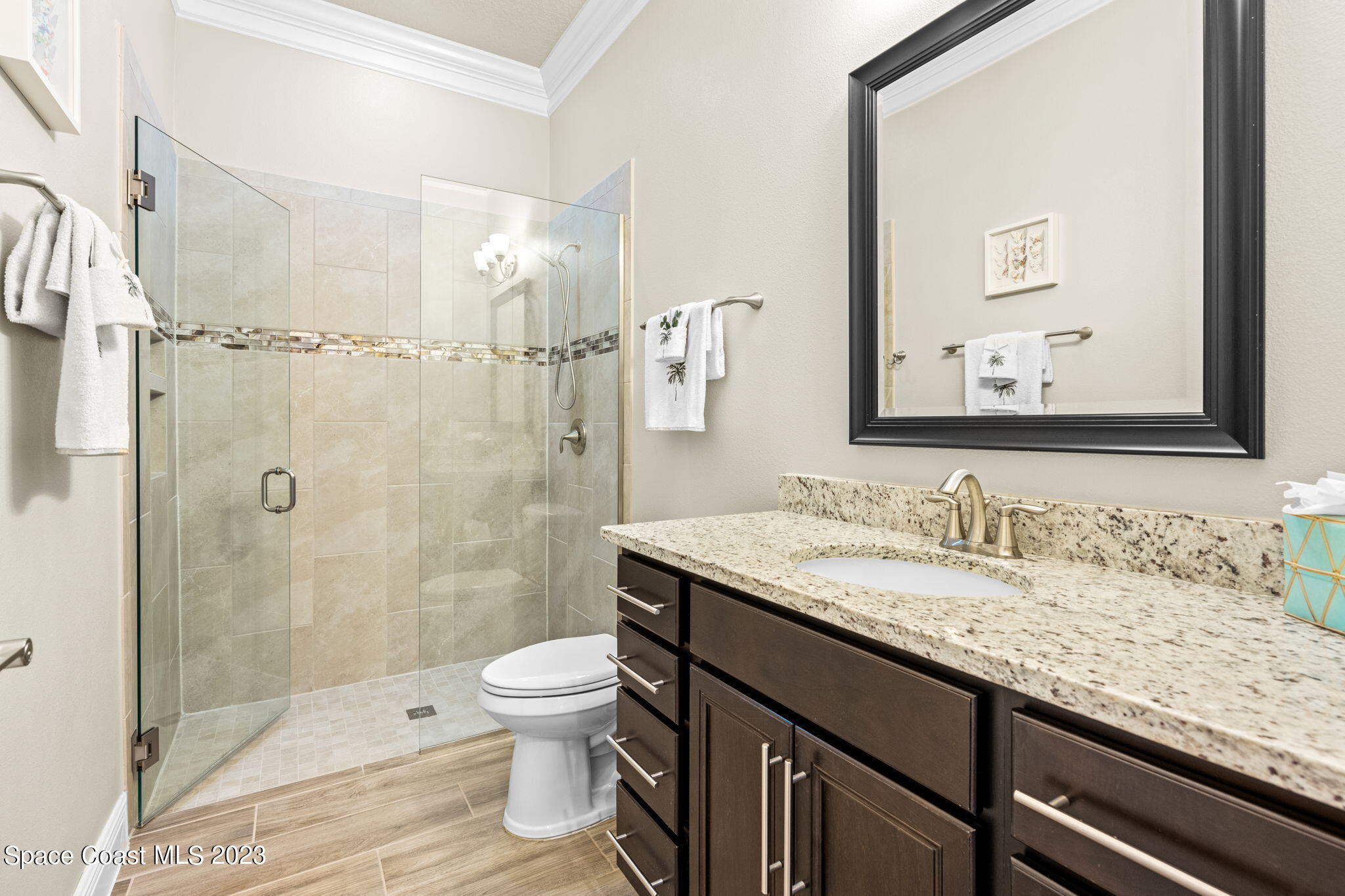 5530 Calder Drive Melbourne, FL 32940 - Photo 35 of 63 a bathroom with a granite countertop sink a toilet and shower