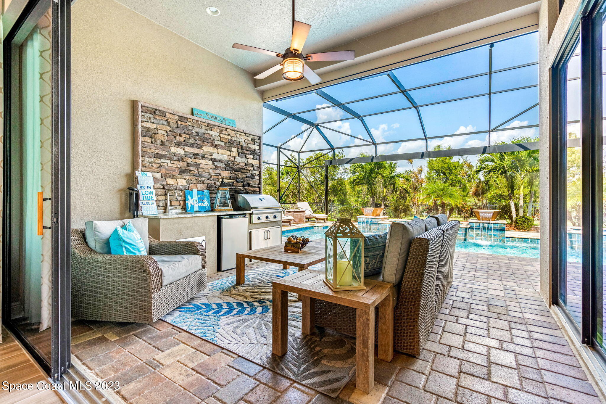 5530 Calder Drive Melbourne, FL 32940 - Photo 36 of 63 a living room with furniture and a floor to ceiling window