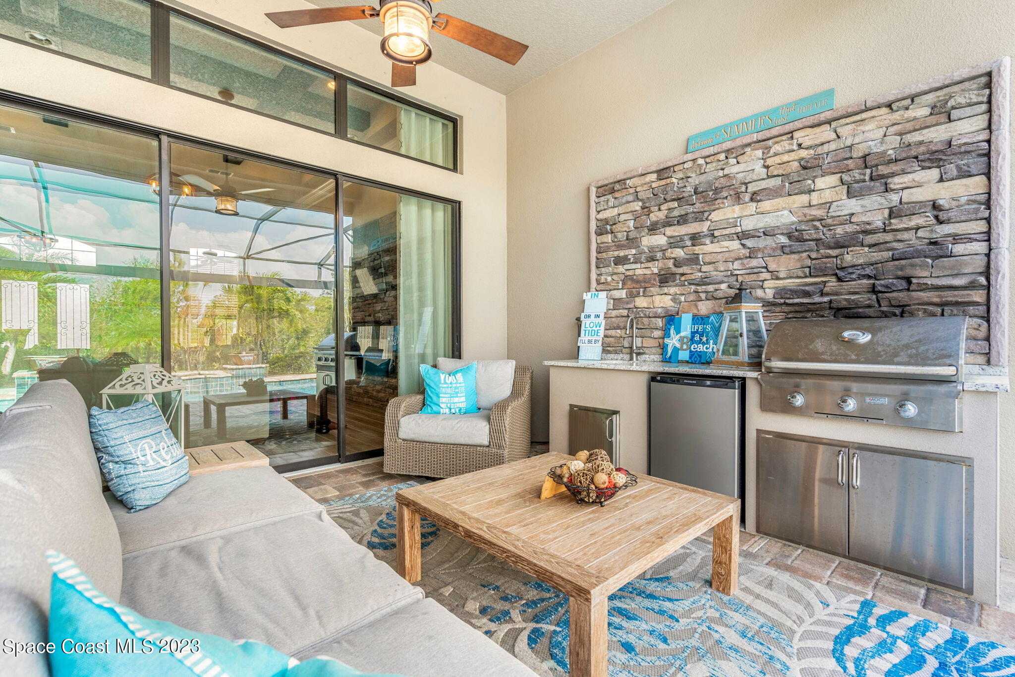5530 Calder Drive Melbourne, FL 32940 - Photo 37 of 63 a living room with furniture and a floor to ceiling window