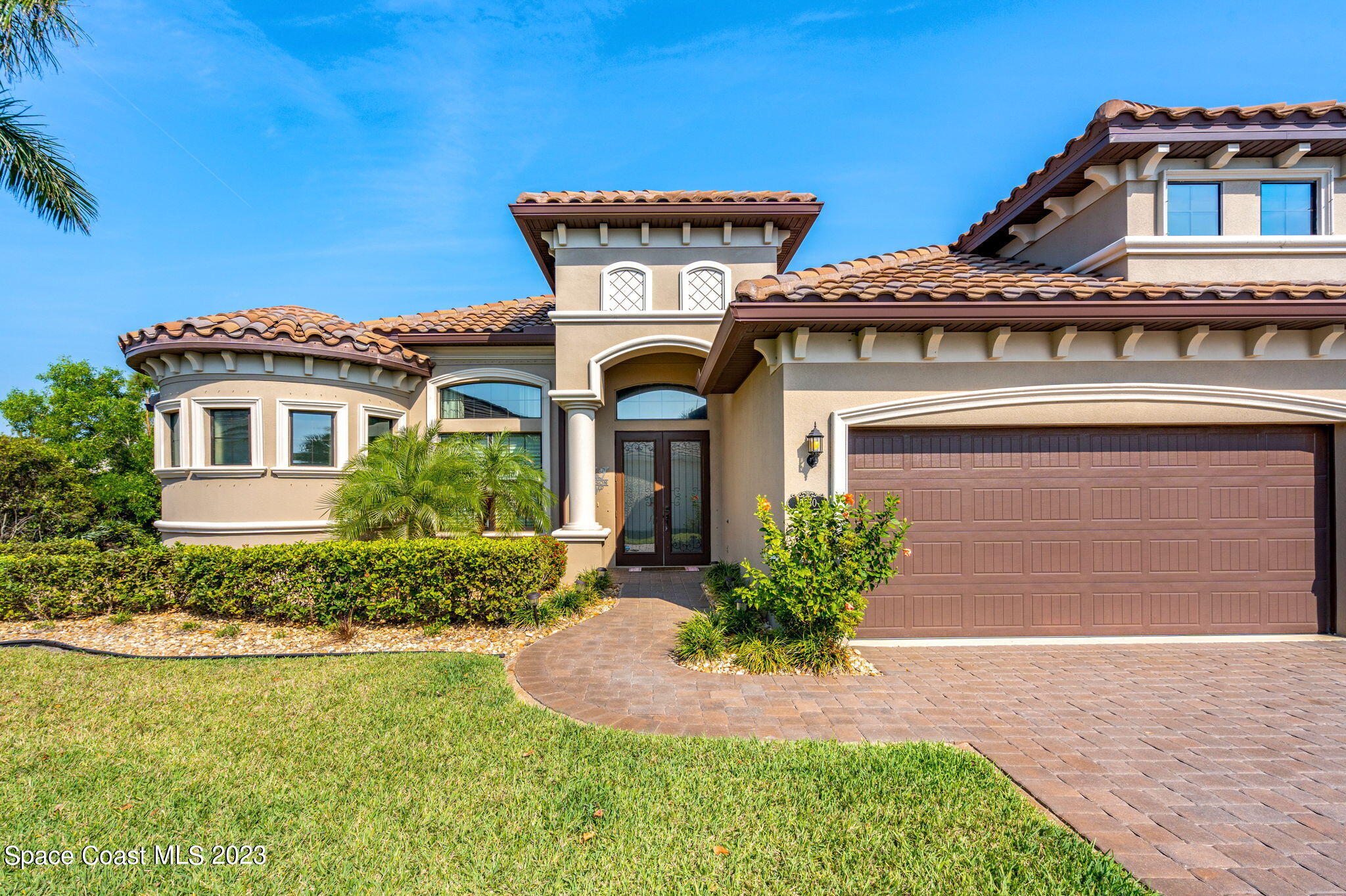 5530 Calder Drive Melbourne, FL 32940 - Photo 4 of 63 a front view of a house with garden