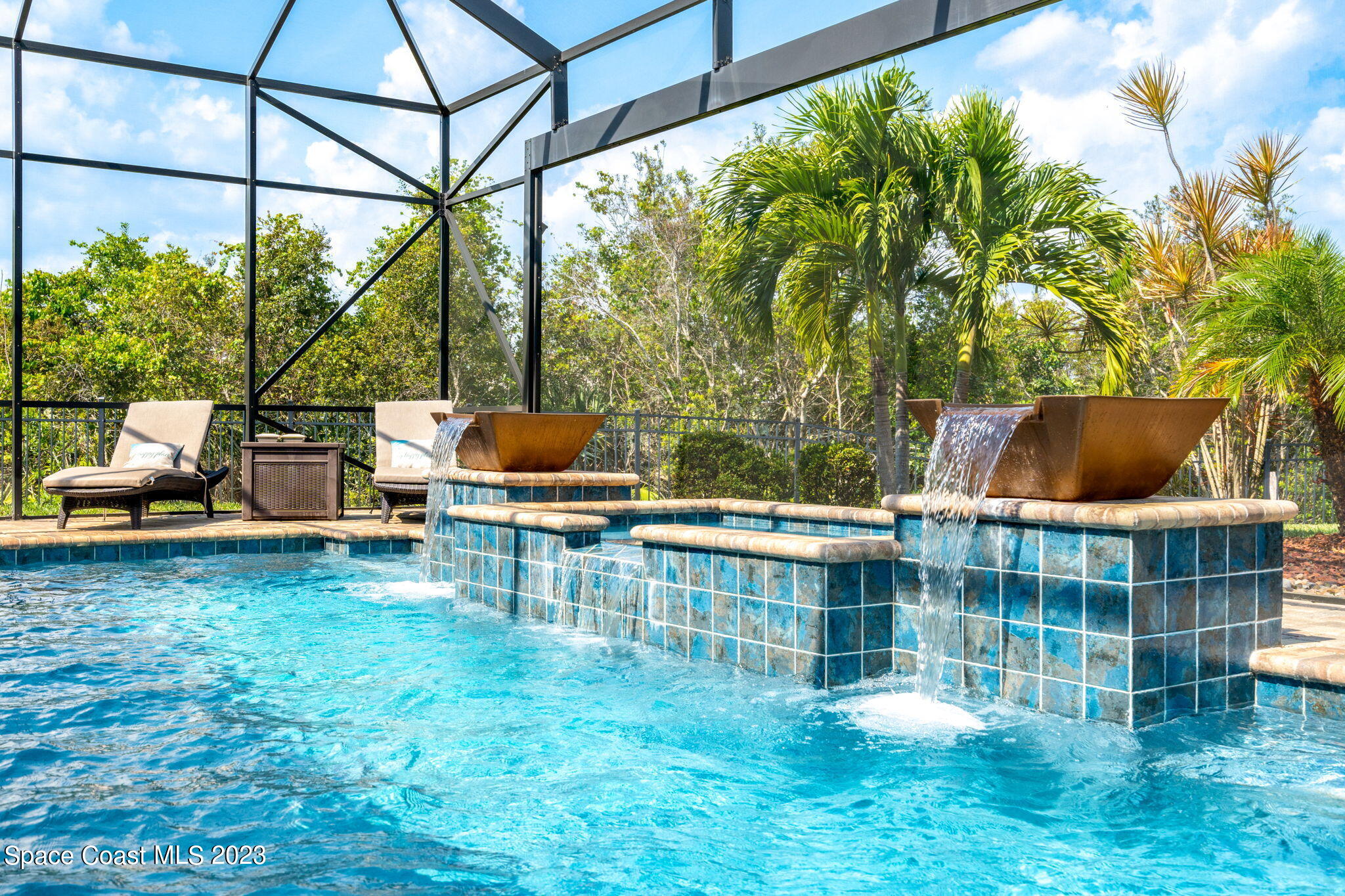 5530 Calder Drive Melbourne, FL 32940 - Photo 46 of 63 a backyard of a house with table and chairs and potted plants