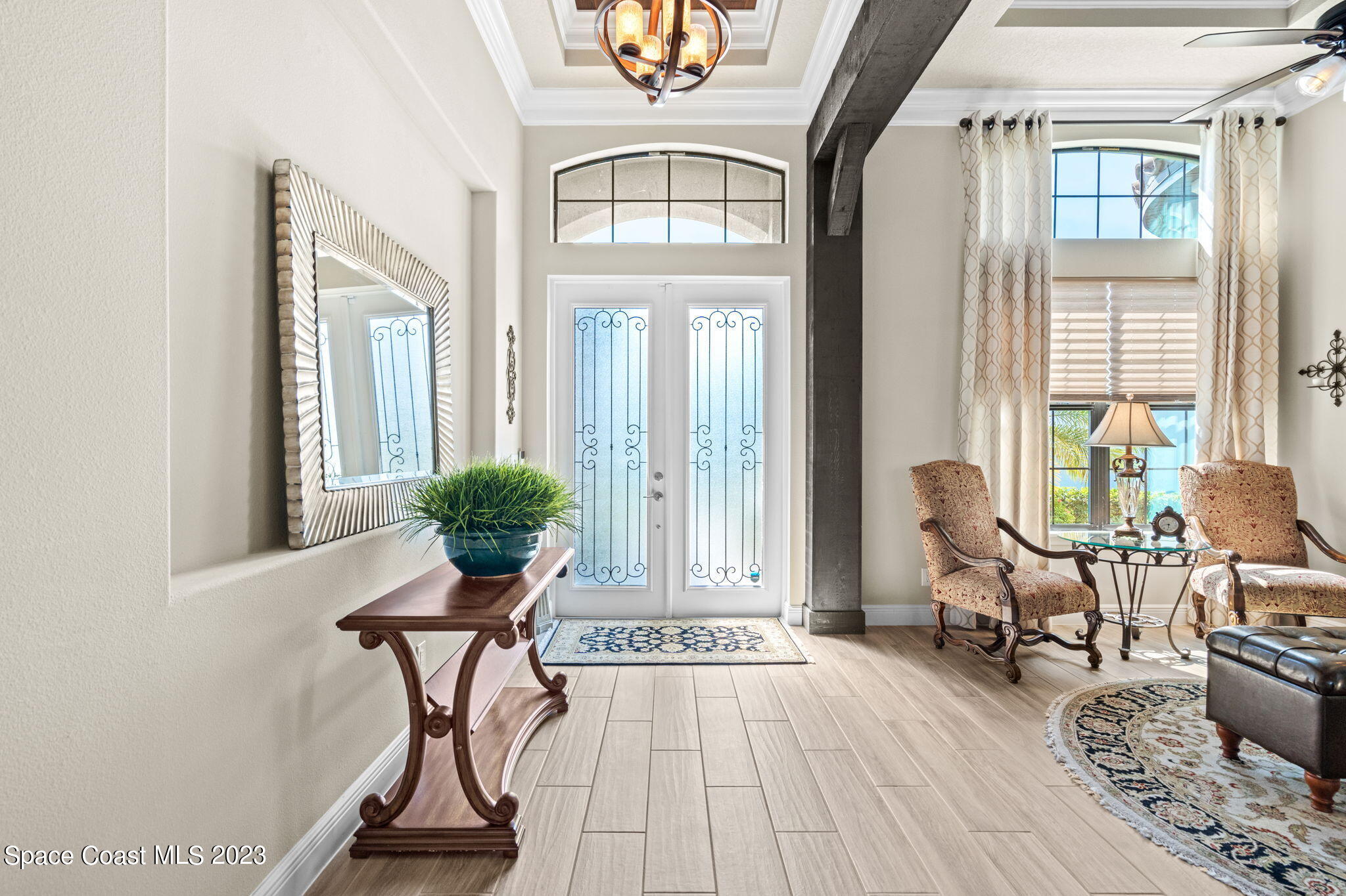 5530 Calder Drive Melbourne, FL 32940 - Photo 5 of 63 a view of a livingroom with furniture and floor to ceiling windows
