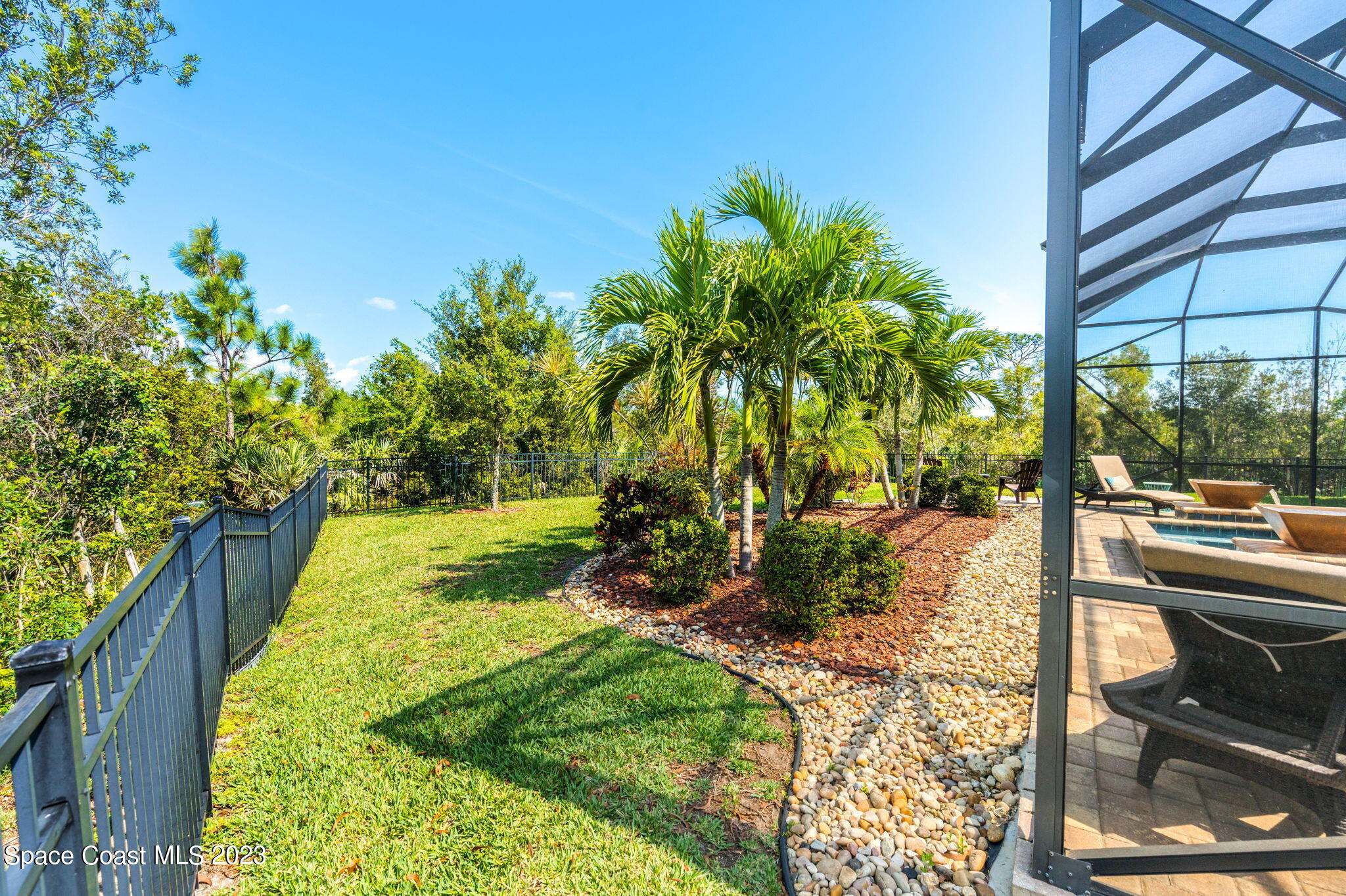 5530 Calder Drive Melbourne, FL 32940 - Photo 51 of 63 a view of backyard with swimming pool and outdoor seating