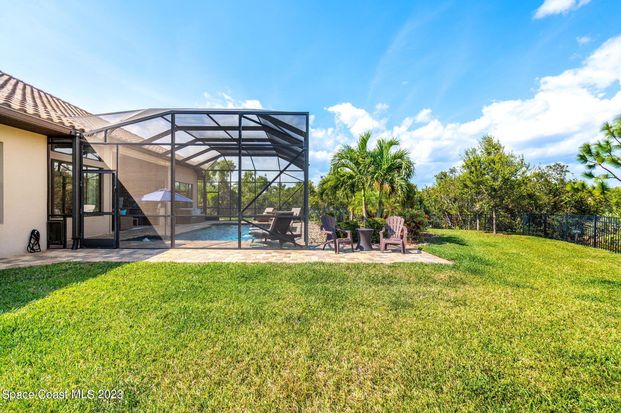 5530 Calder Drive Melbourne, FL 32940 - Photo 54 of 63 a view of a swimming pool with a bench and trees