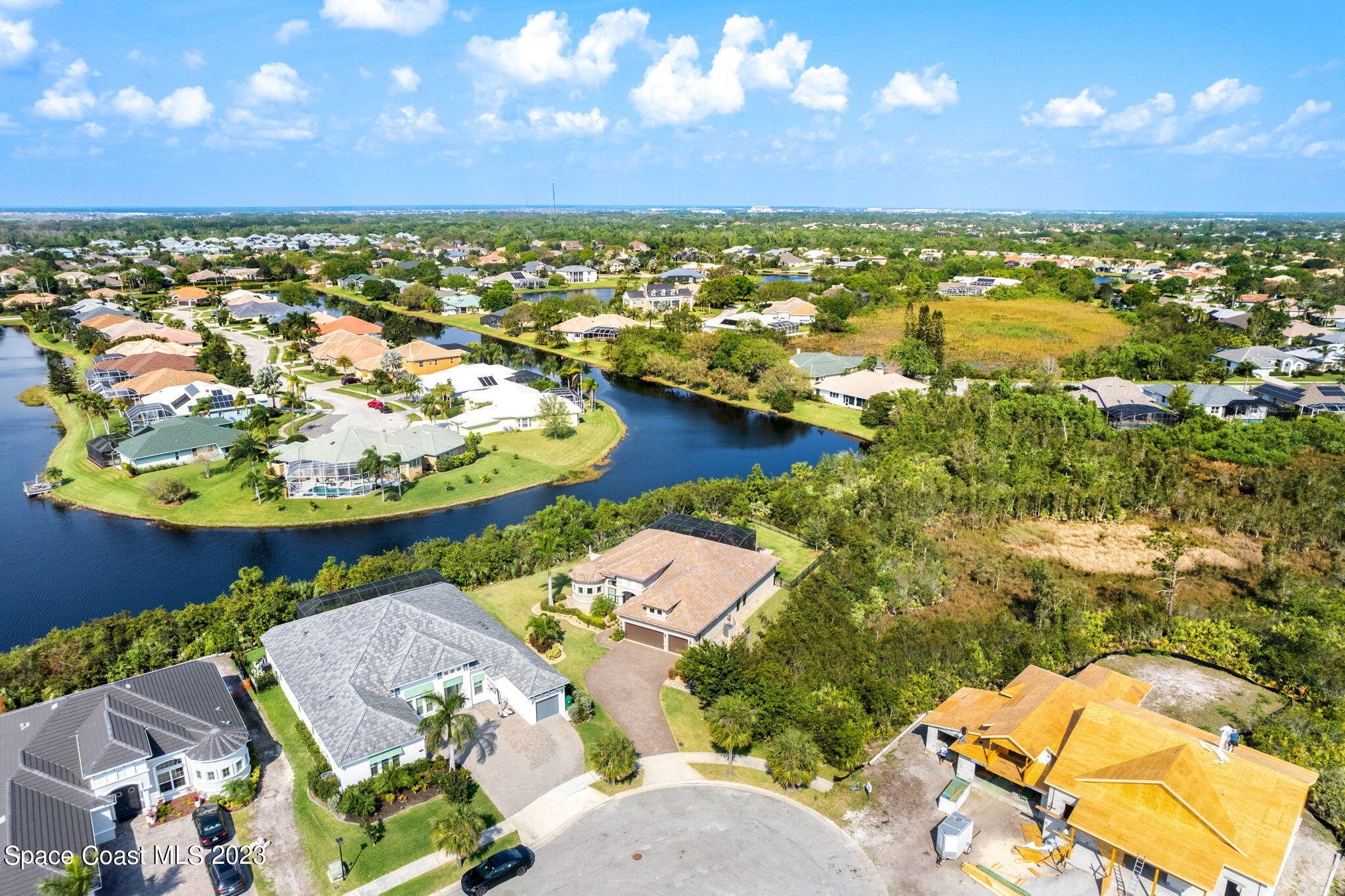 5530 Calder Drive Melbourne, FL 32940 - Photo 63 of 63 an aerial view of a house with a yard and lake view