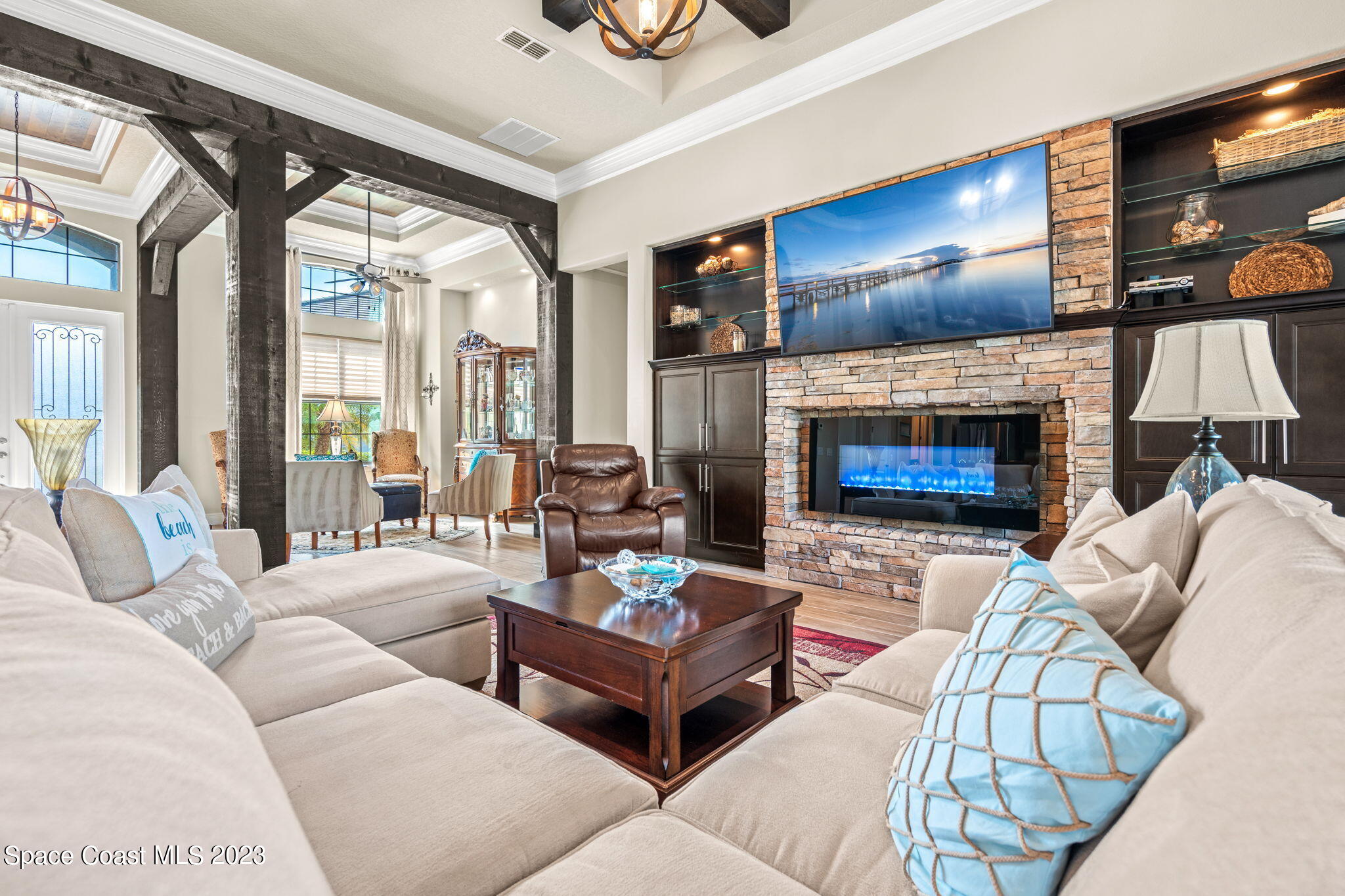5530 Calder Drive Melbourne, FL 32940 - Photo 9 of 63 a living room with furniture flat screen tv and a fireplace