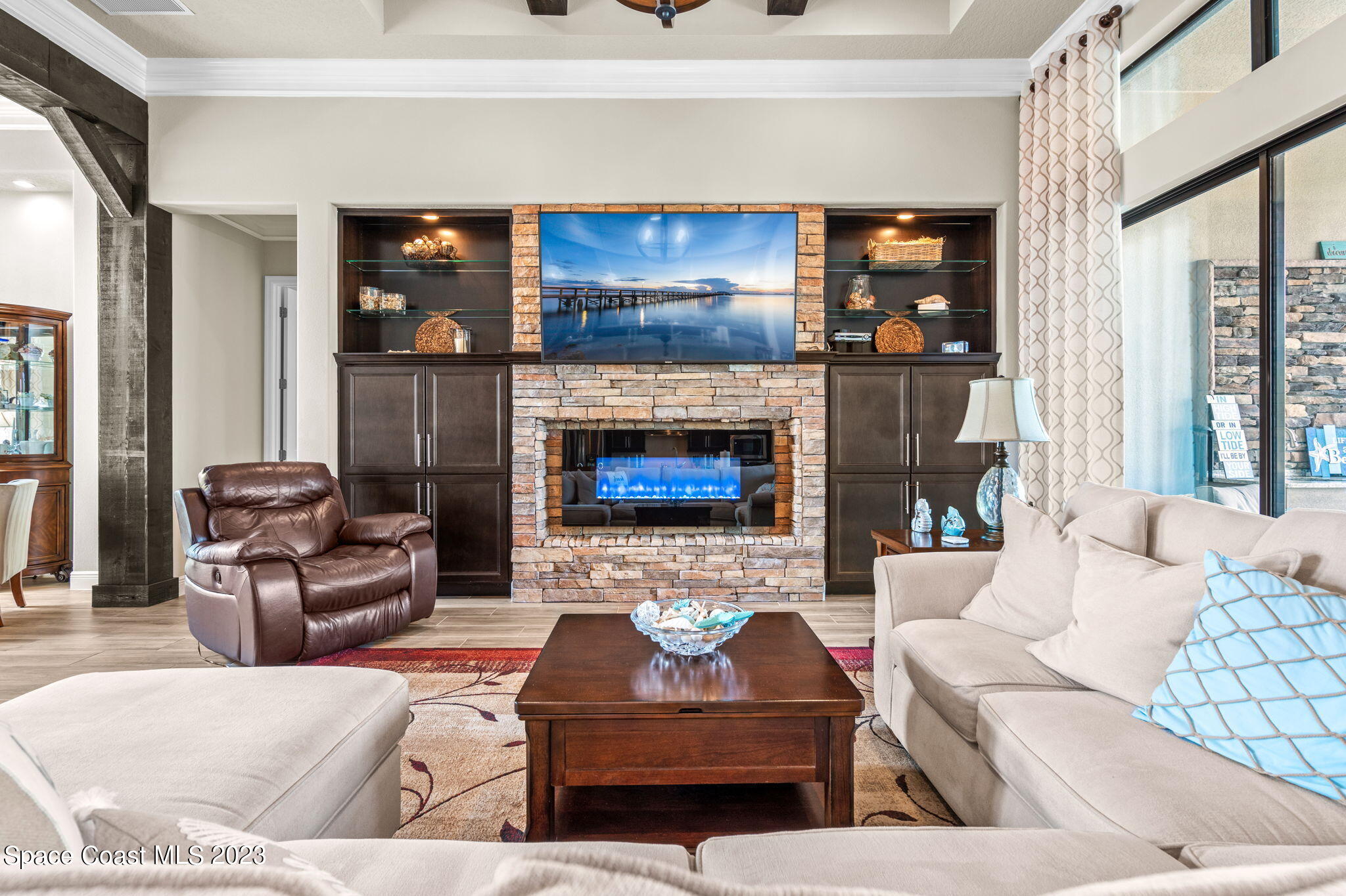 5530 Calder Drive Melbourne, FL 32940 - Photo 10 of 63 a living room with furniture and a fireplace