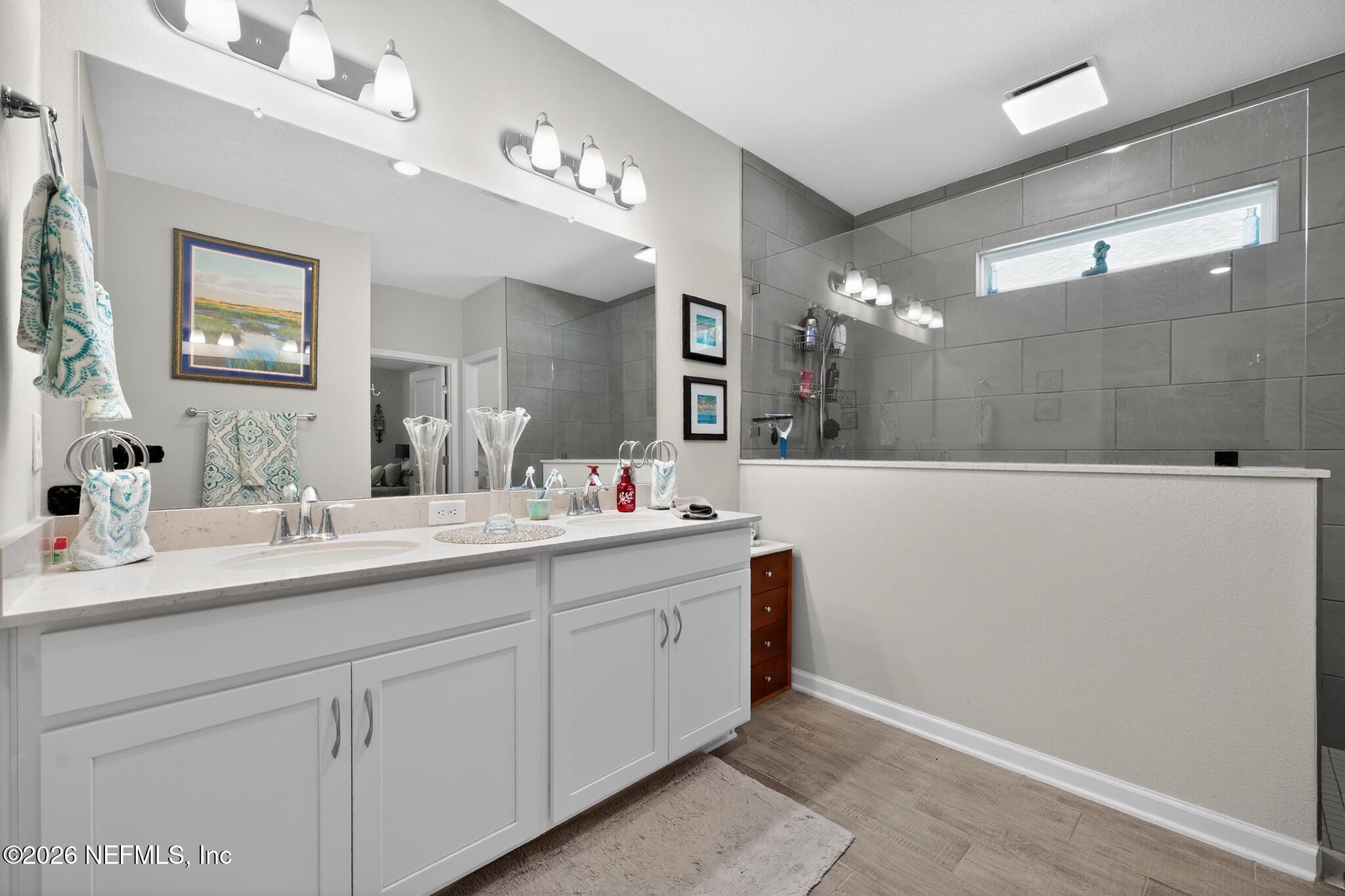 75505 Banyan Way Yulee, FL 32097 - Photo 24 of 30 a bathroom with a sink a large mirror and vanity