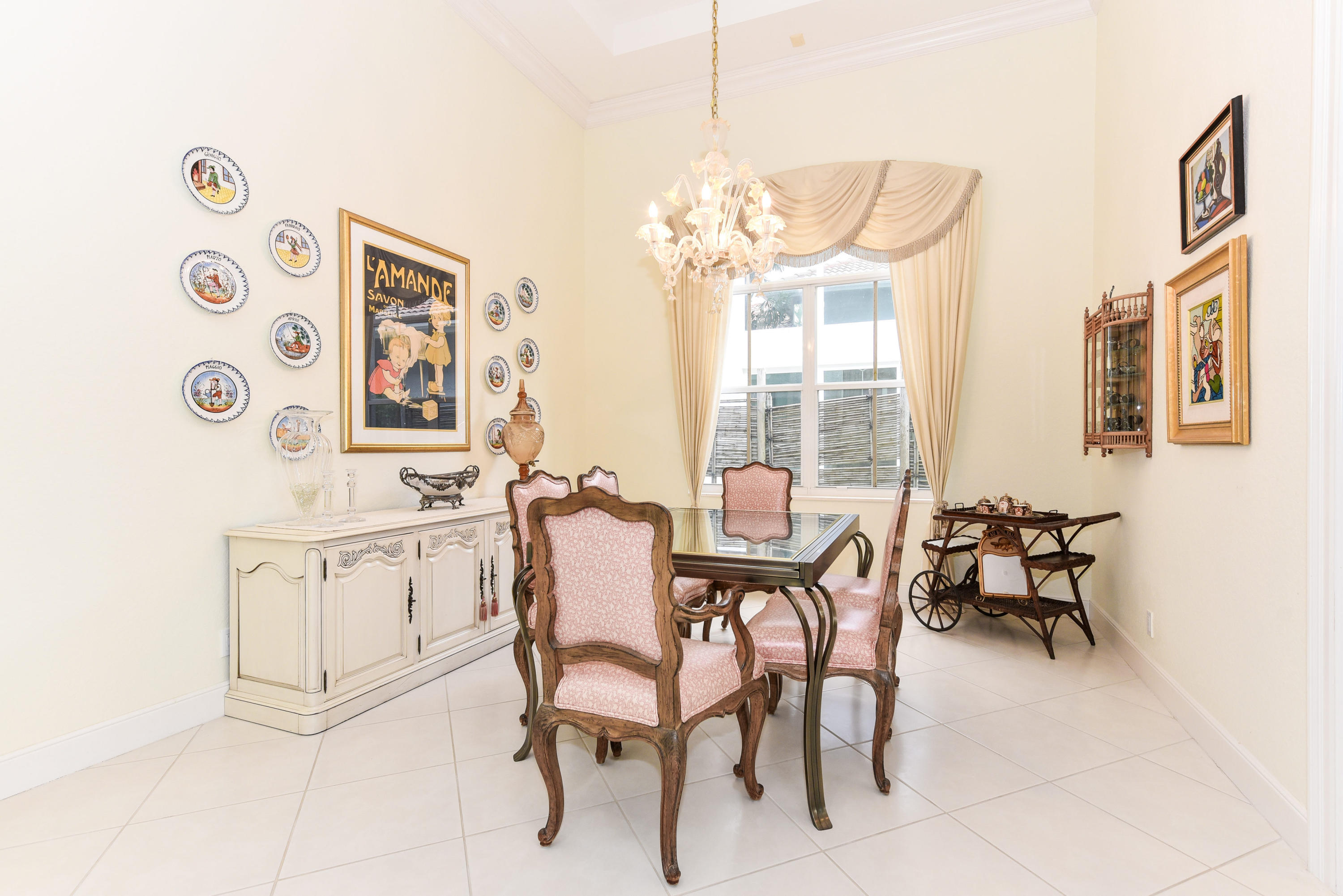 4101 Northwest 60th Circle Boca Raton, FL 33496 - Photo 8 of 45 a view of a dining room with furniture a chandelier and a window