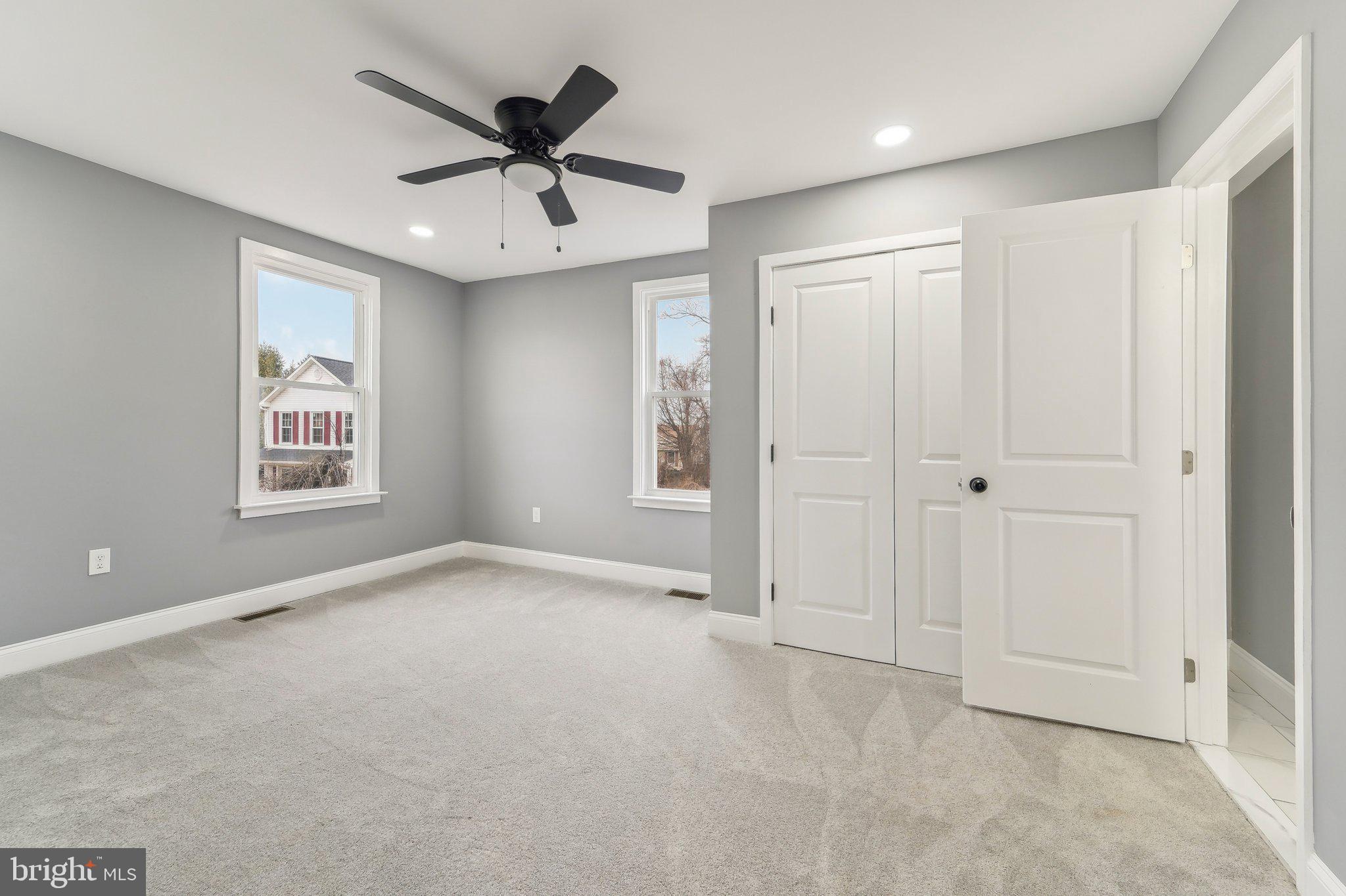 7008 Windsor Mill Road Baltimore, MD 21207 - Photo 24 of 34 an empty room with ceiling fan and windows