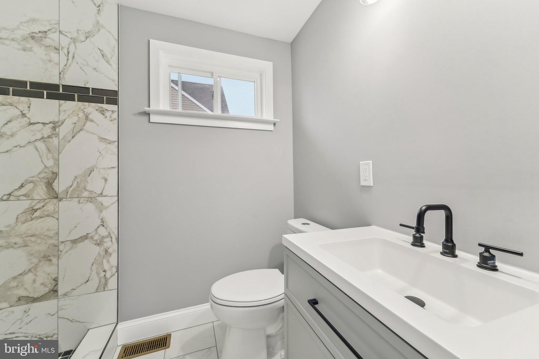 7008 Windsor Mill Road Baltimore, MD 21207 - Photo 26 of 34 a bathroom with a sink and a toilet