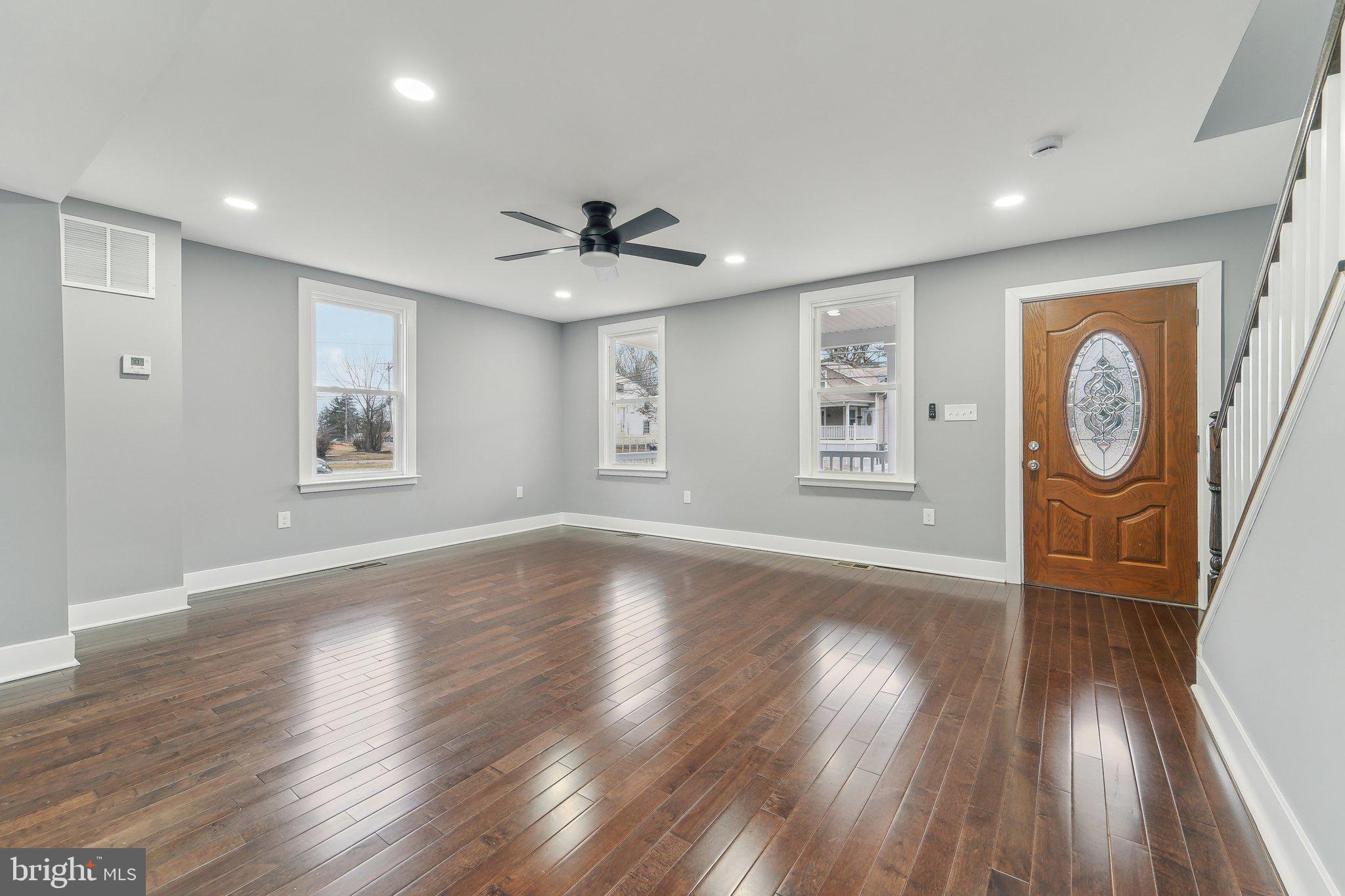 7008 Windsor Mill Road Baltimore, MD 21207 - Photo 6 of 34 a view of a big room with wooden floor and windows