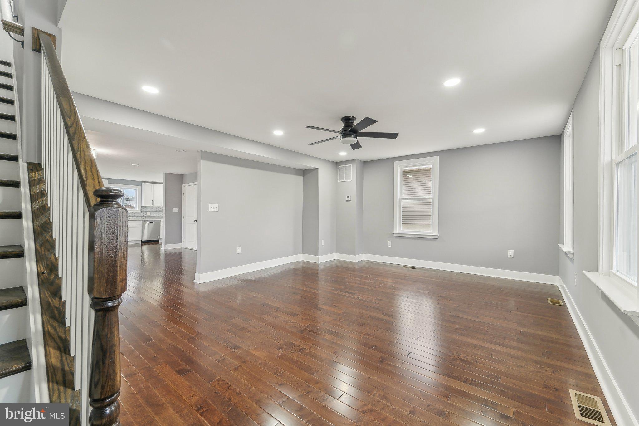 7008 Windsor Mill Road Baltimore, MD 21207 - Photo 8 of 34 a view of a livingroom with wooden floor and staircase