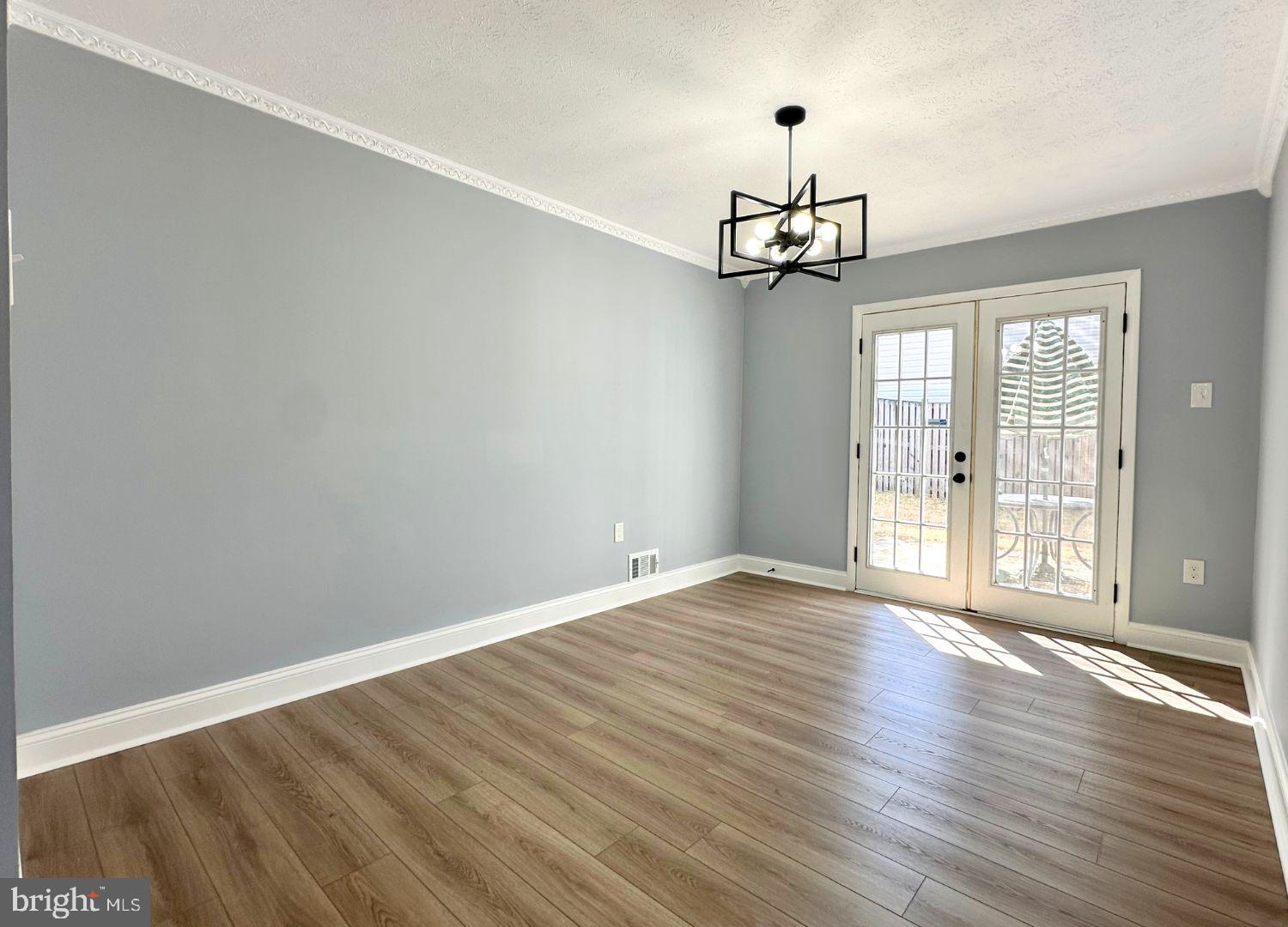 1855 Montreal Road Severn, MD 21144 - Photo 16 of 30 a view of an empty room with wooden floor and a window