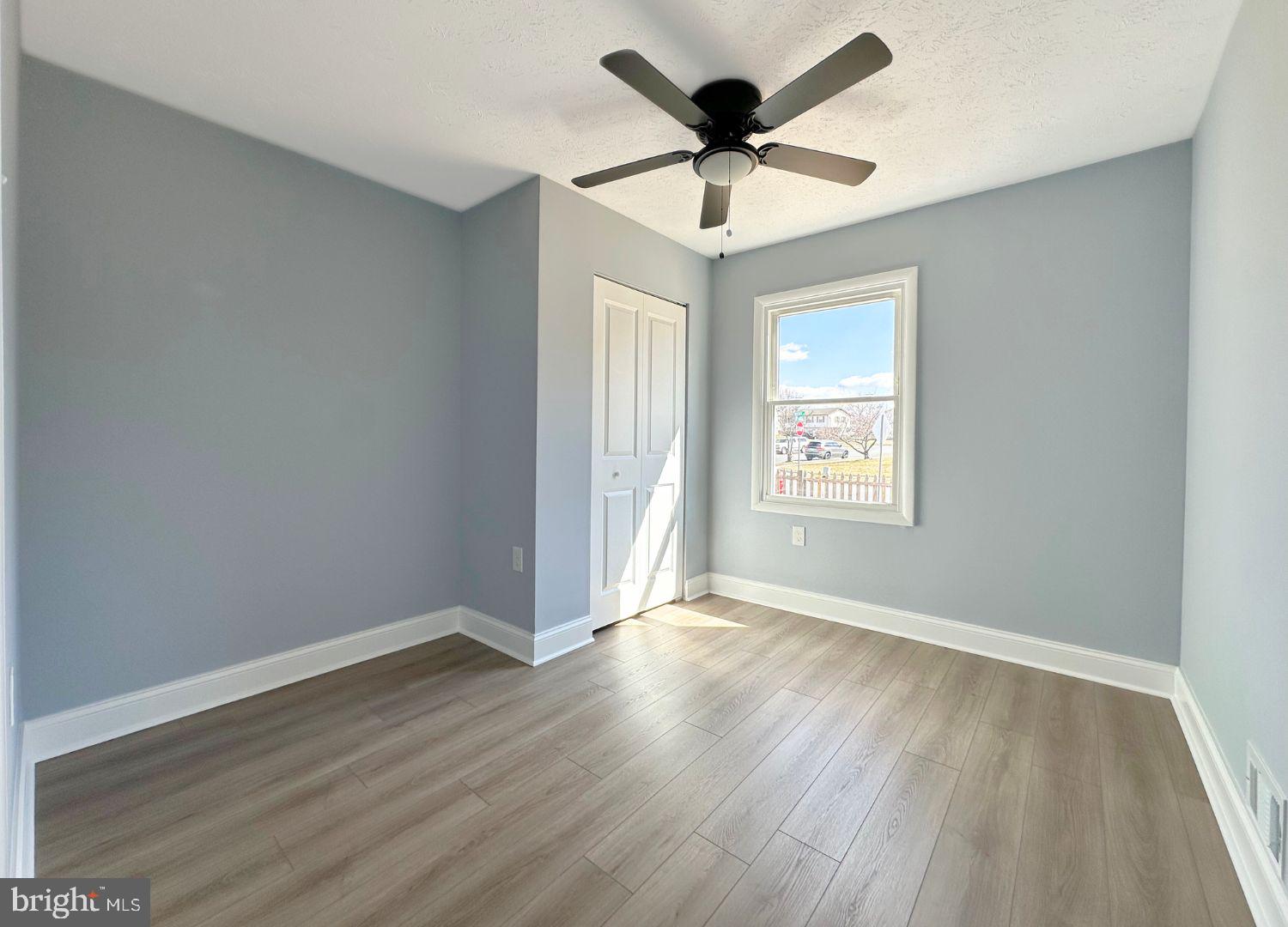 1855 Montreal Road Severn, MD 21144 - Photo 17 of 30 an empty room with wooden floor and windows